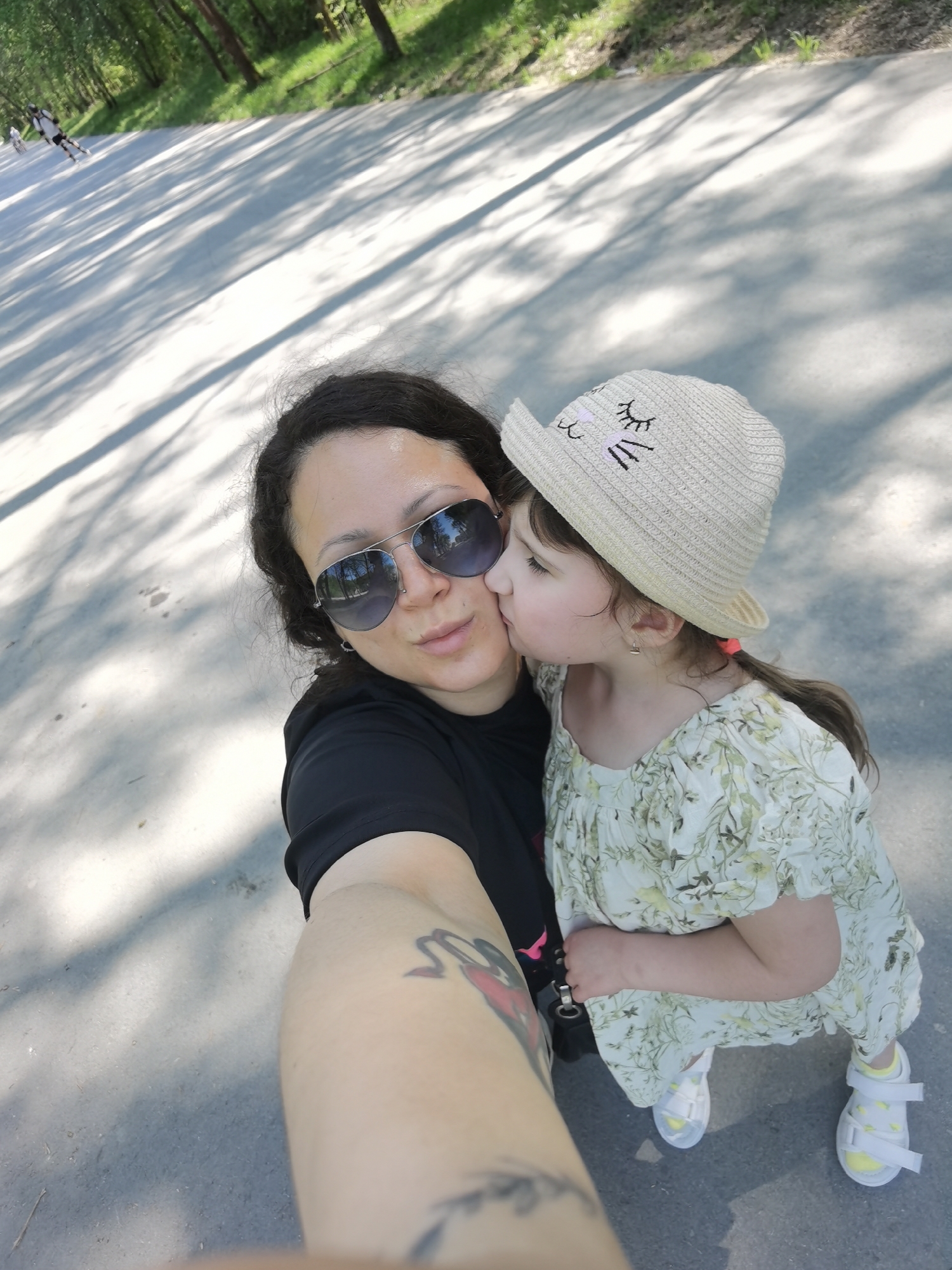 Mother and daughter visit wooden animal sculptures in Perm park
