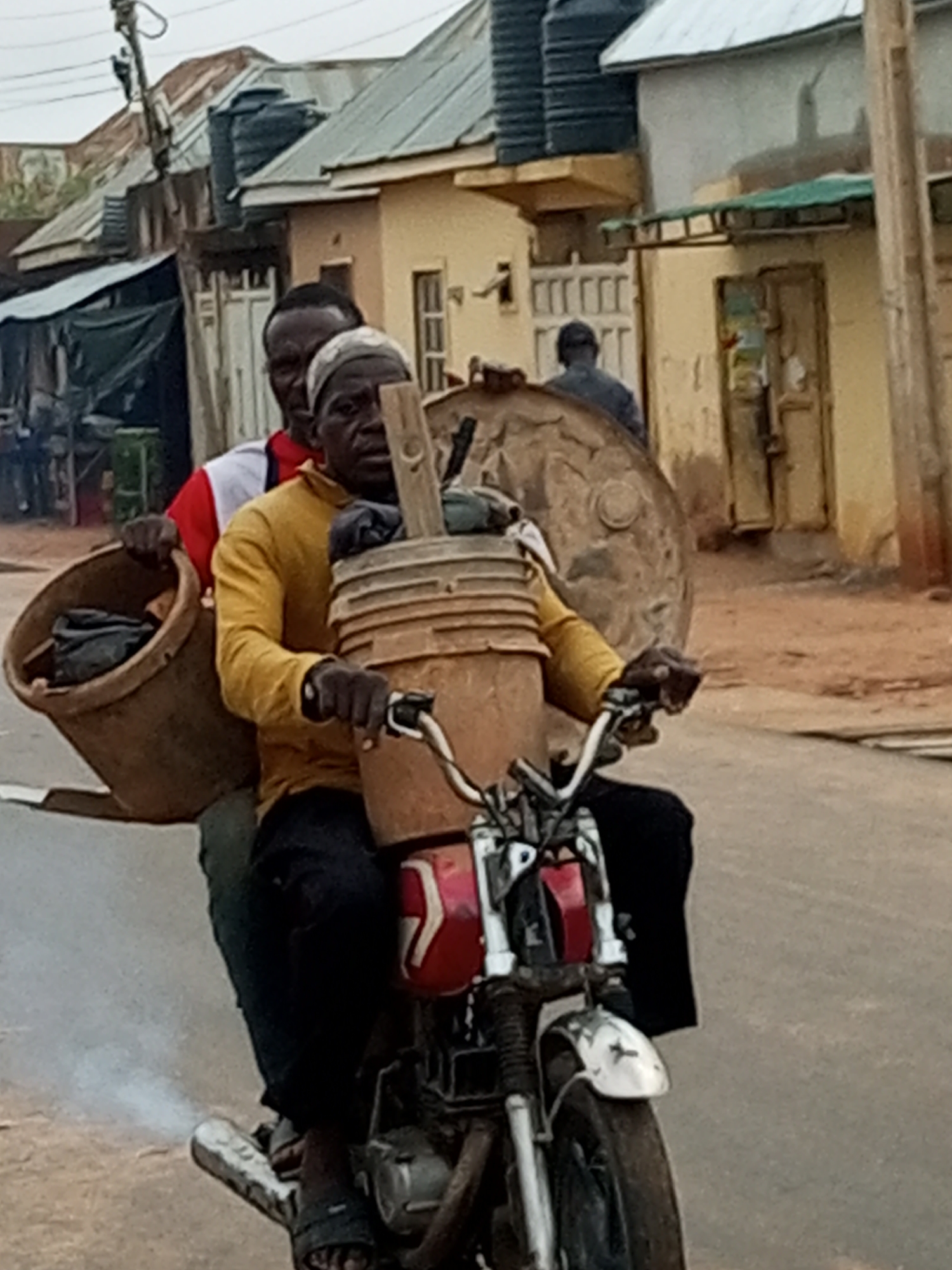 Motorcycle duo navigating a busy market or residential street