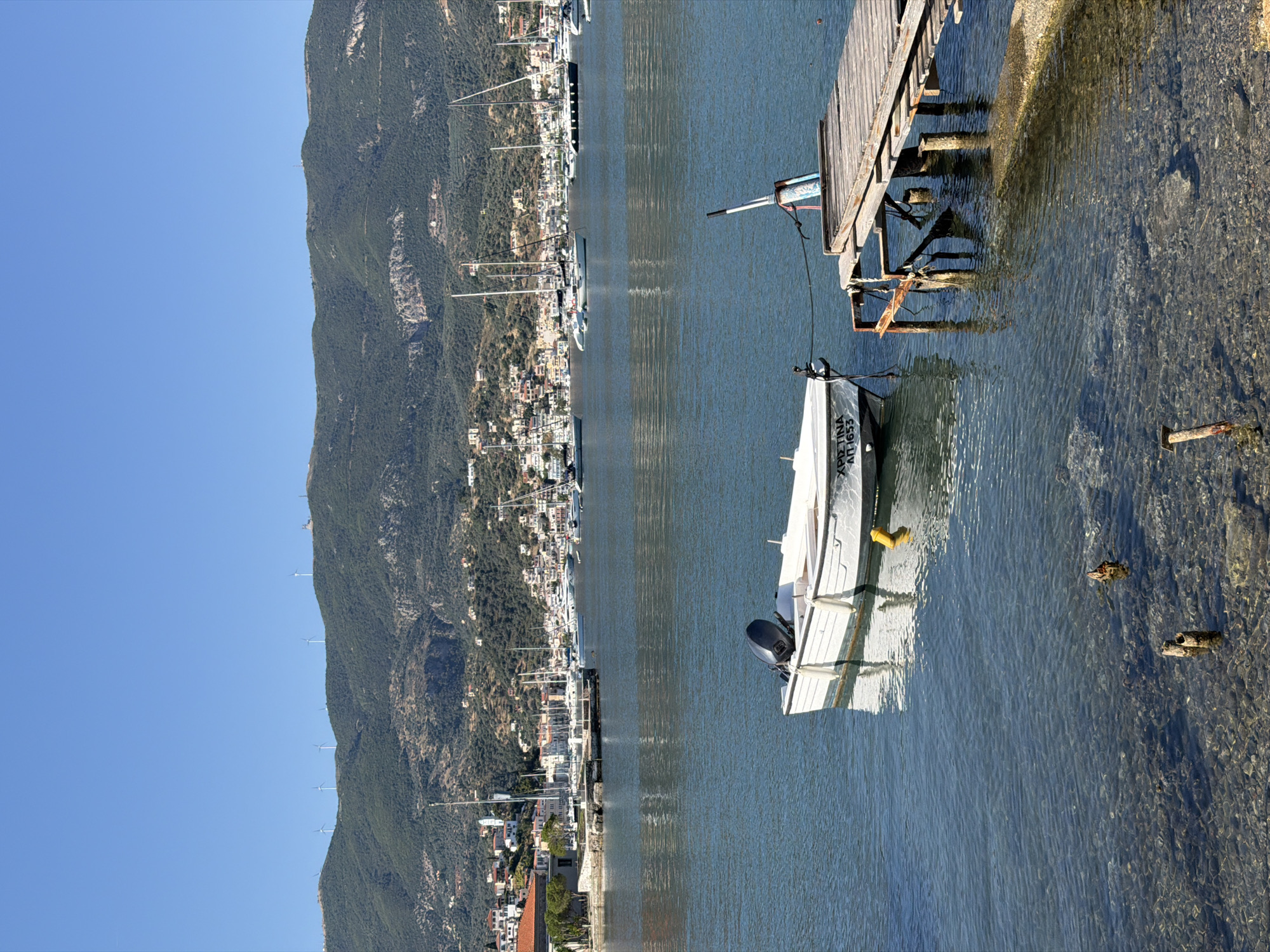 Artist sketches flowers, boats during morning in Poros harbor