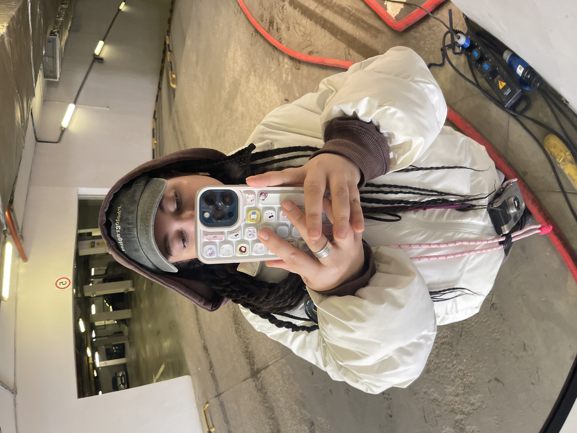 Person Takes Mirror Selfie in Layered Winter Clothing