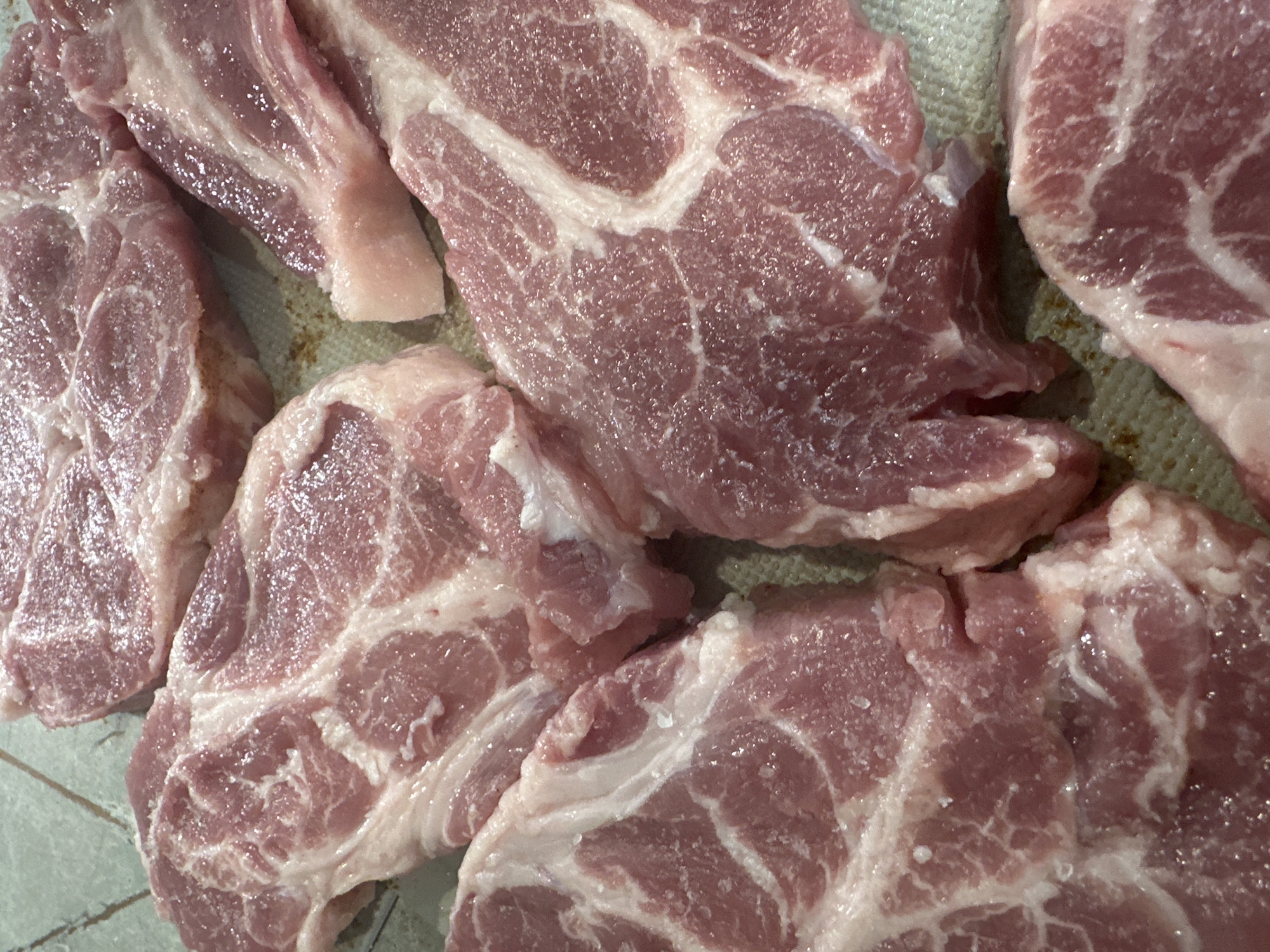 Raw pork cuts seasoned for cooking preparation