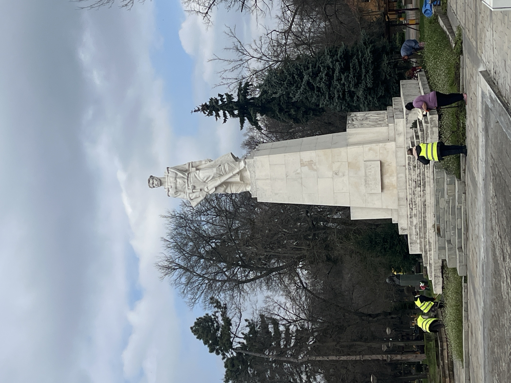 Workers maintain landscaping at soldier monument in Karnobat