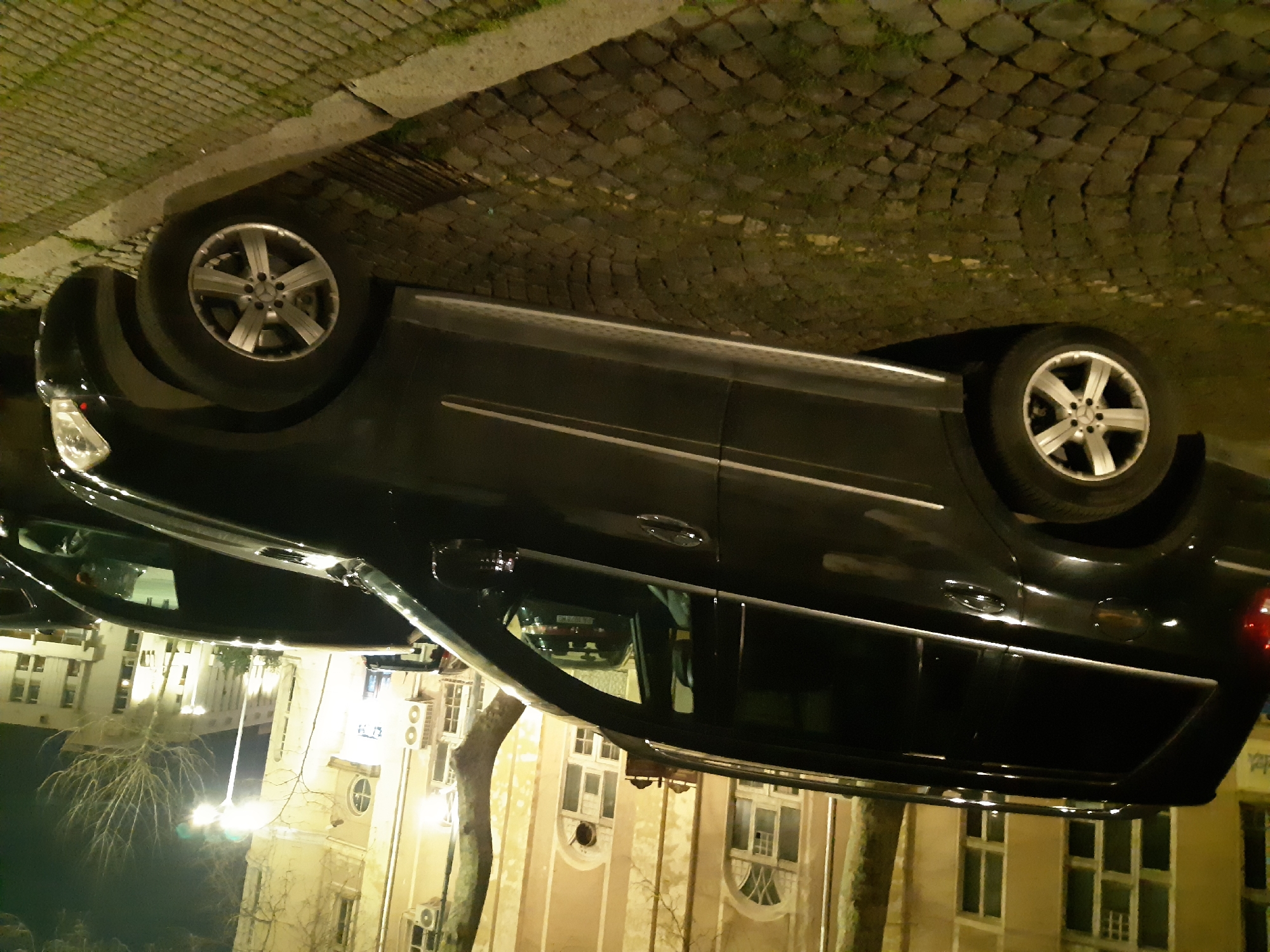Evening street scene captured in historic Plovdiv with parked cars
