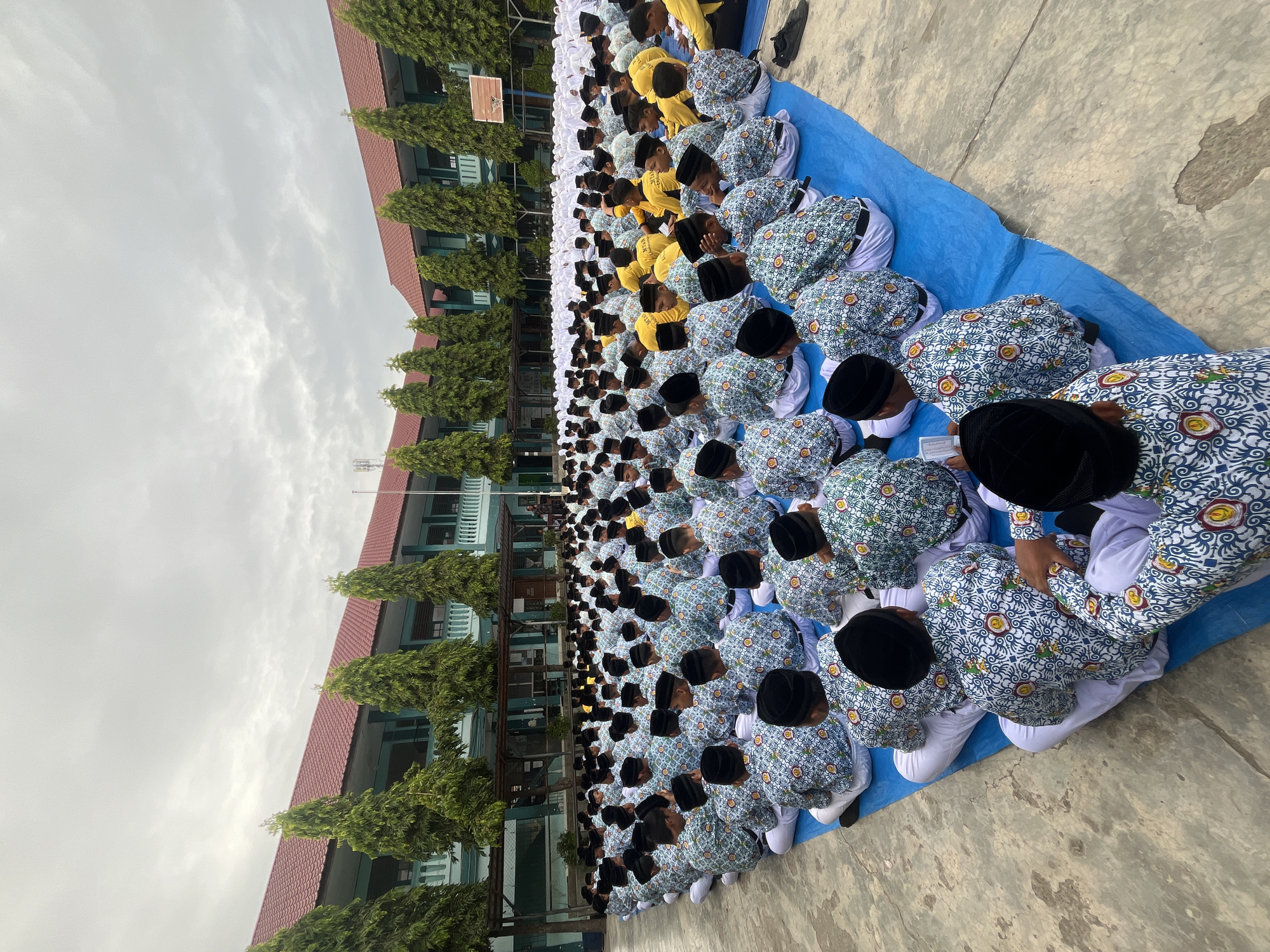 School assembly underway in Lhokseumawe courtyard, students in uniform
