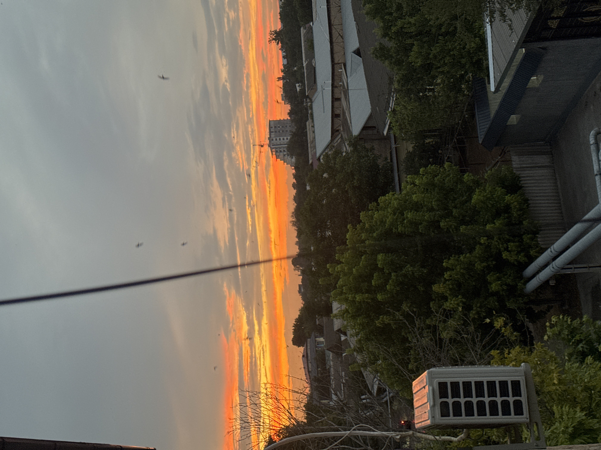 Sunset over Yangiiul rooftops and city streets