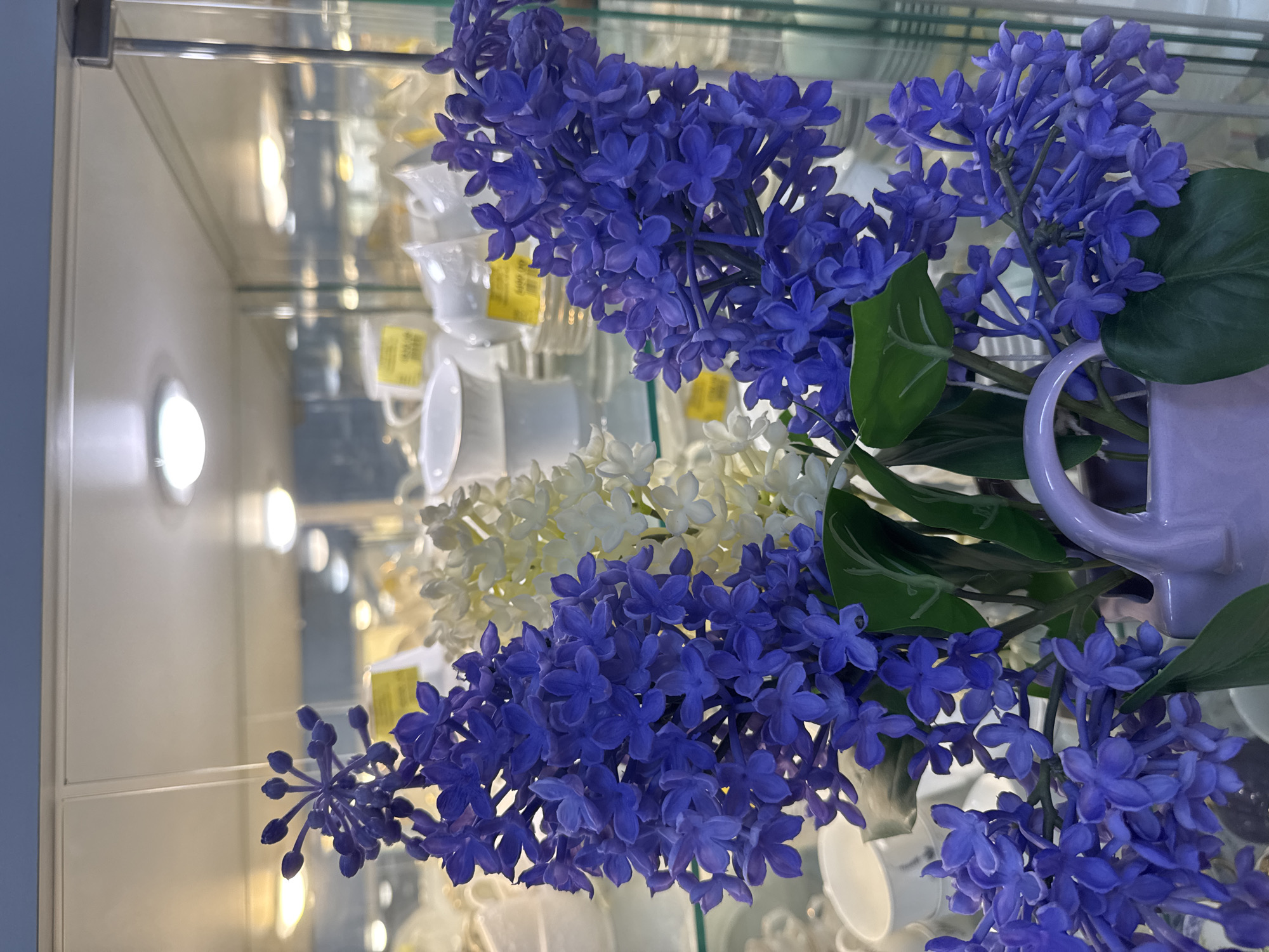 Woman shops for artificial flowers in Klin home goods store