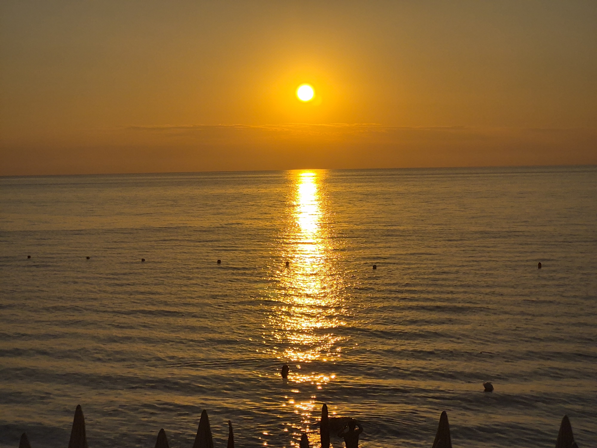Tropea coastline at golden hour — sea, cliffs, and sunset.