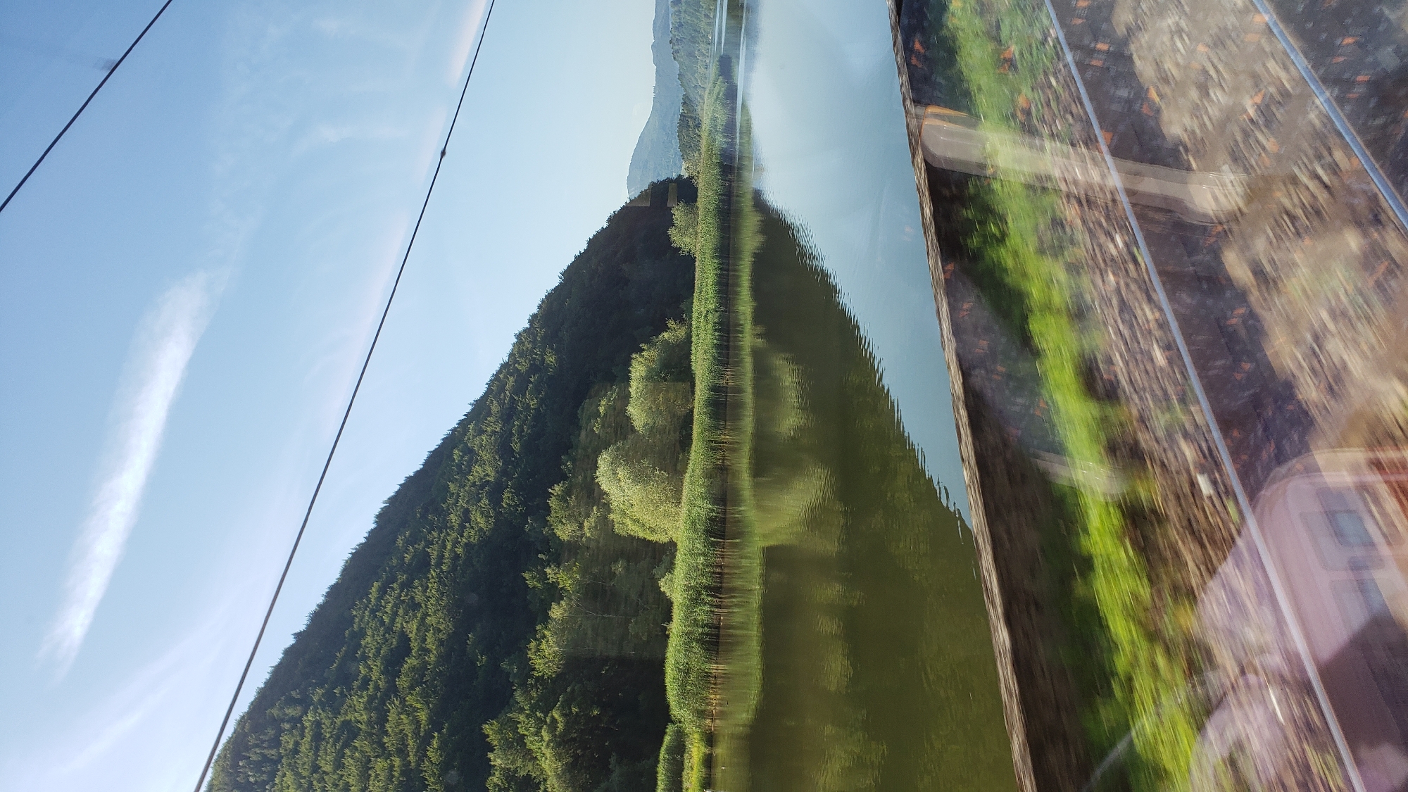 Quiet lakeside view beneath forested hills in rural Slovakia