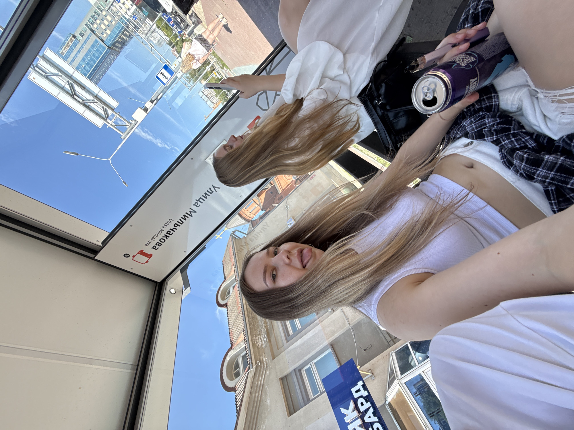 Selfies and downtime at a glass bus stop in Perm