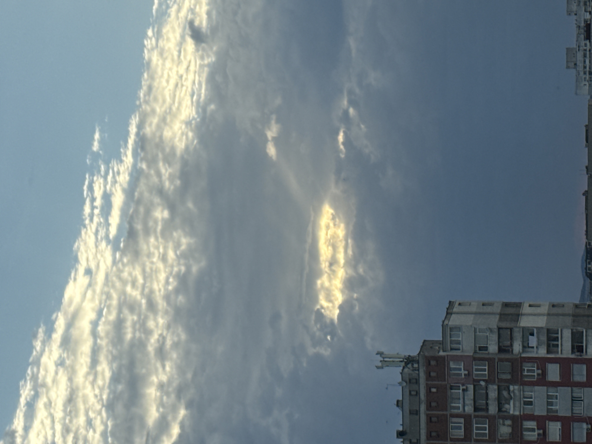 Stormy skies over a city, plus a Venetian mask on display