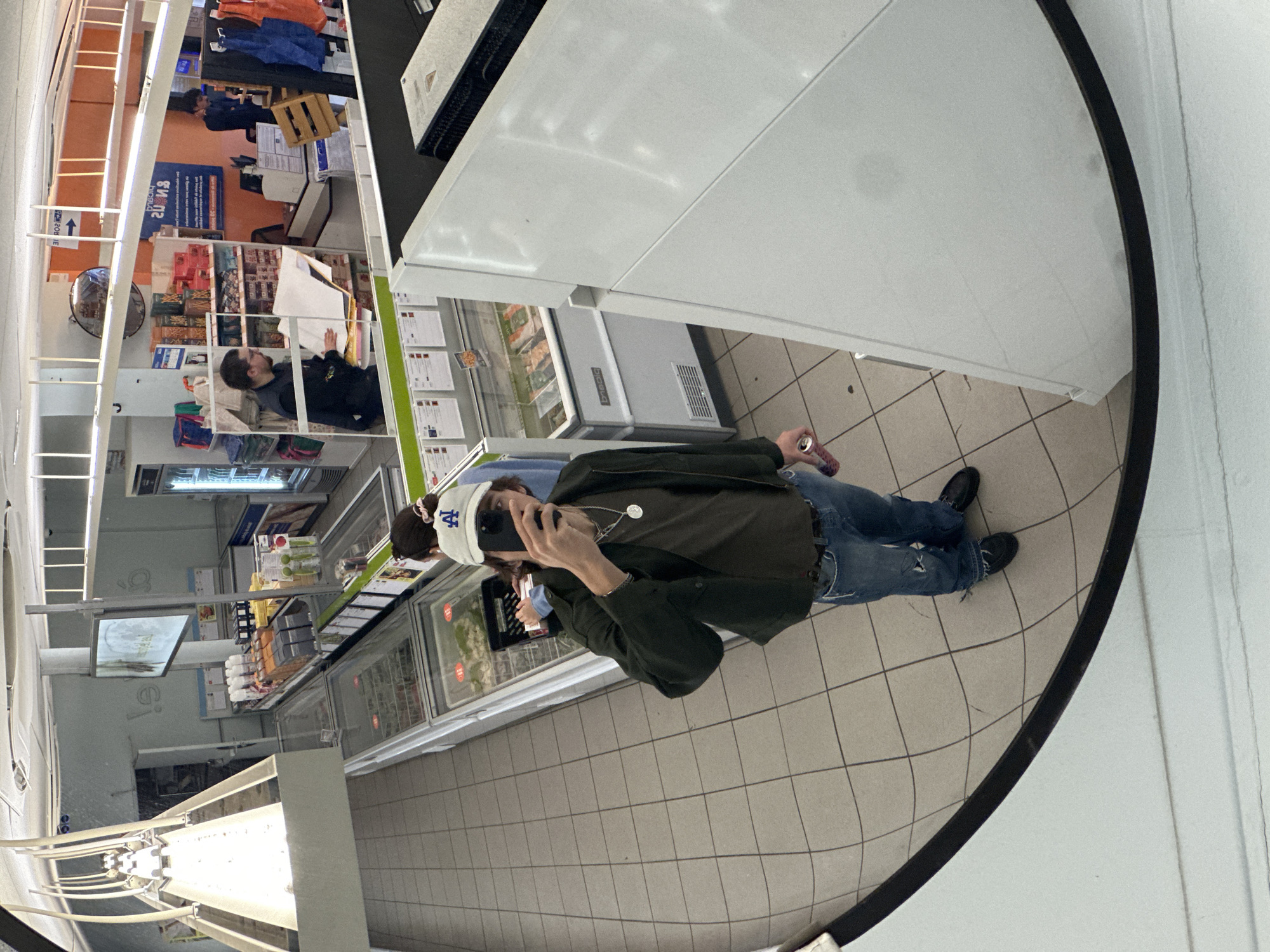 Shopper takes selfie in Paris grocery store mirror