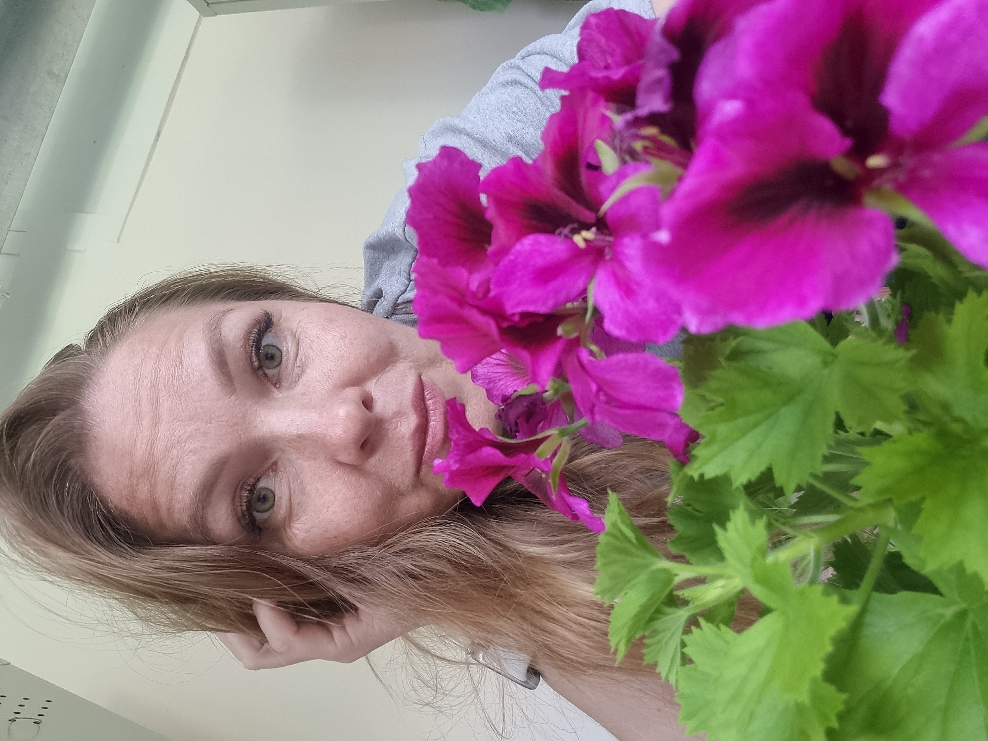Woman takes flower selfies in Kemul, Russia