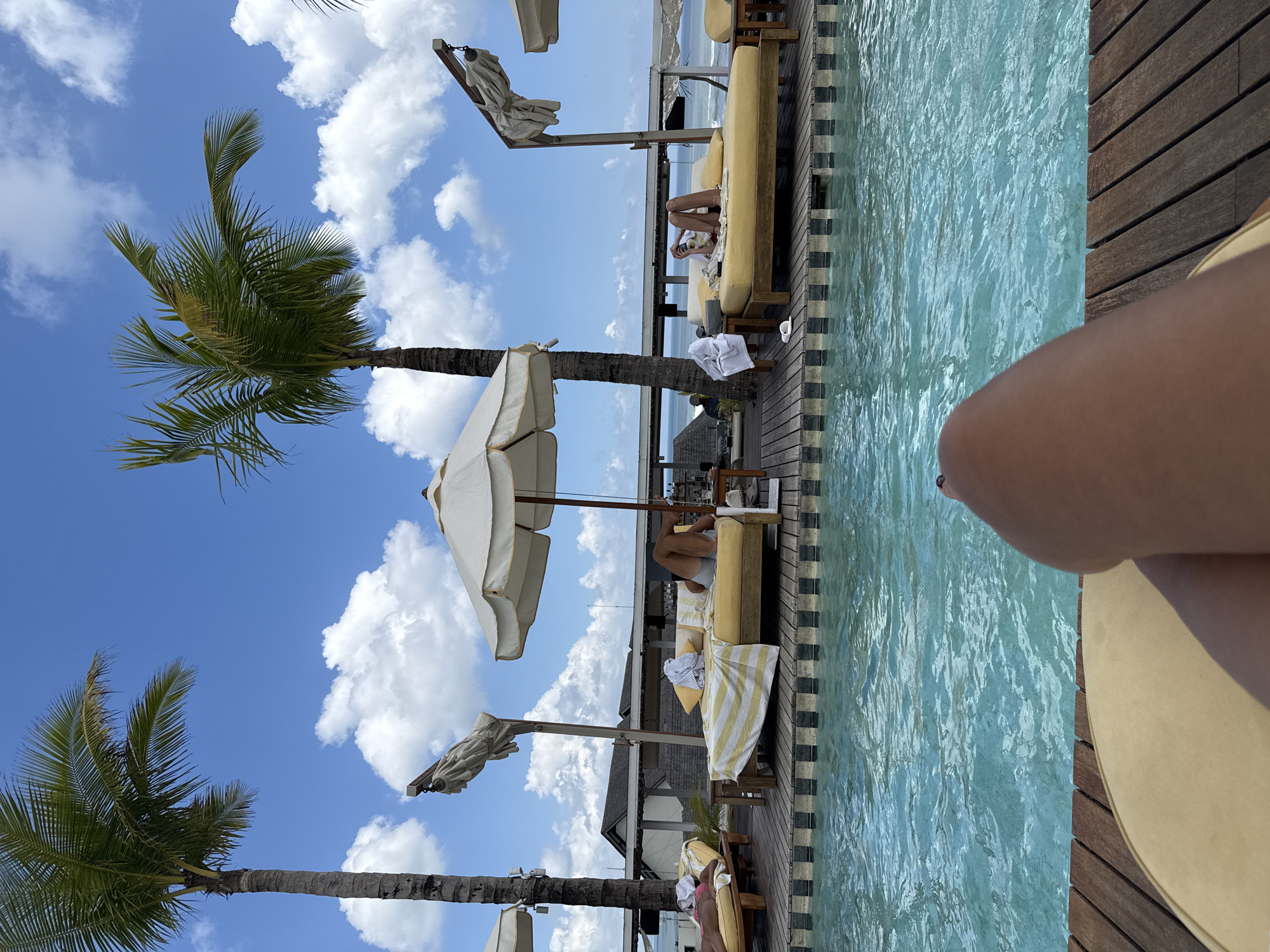 Tourist relaxes poolside at North Kuta resort early morning