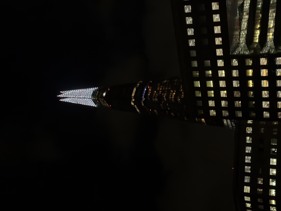 Shard's spire illuminated with bright white lights in London
