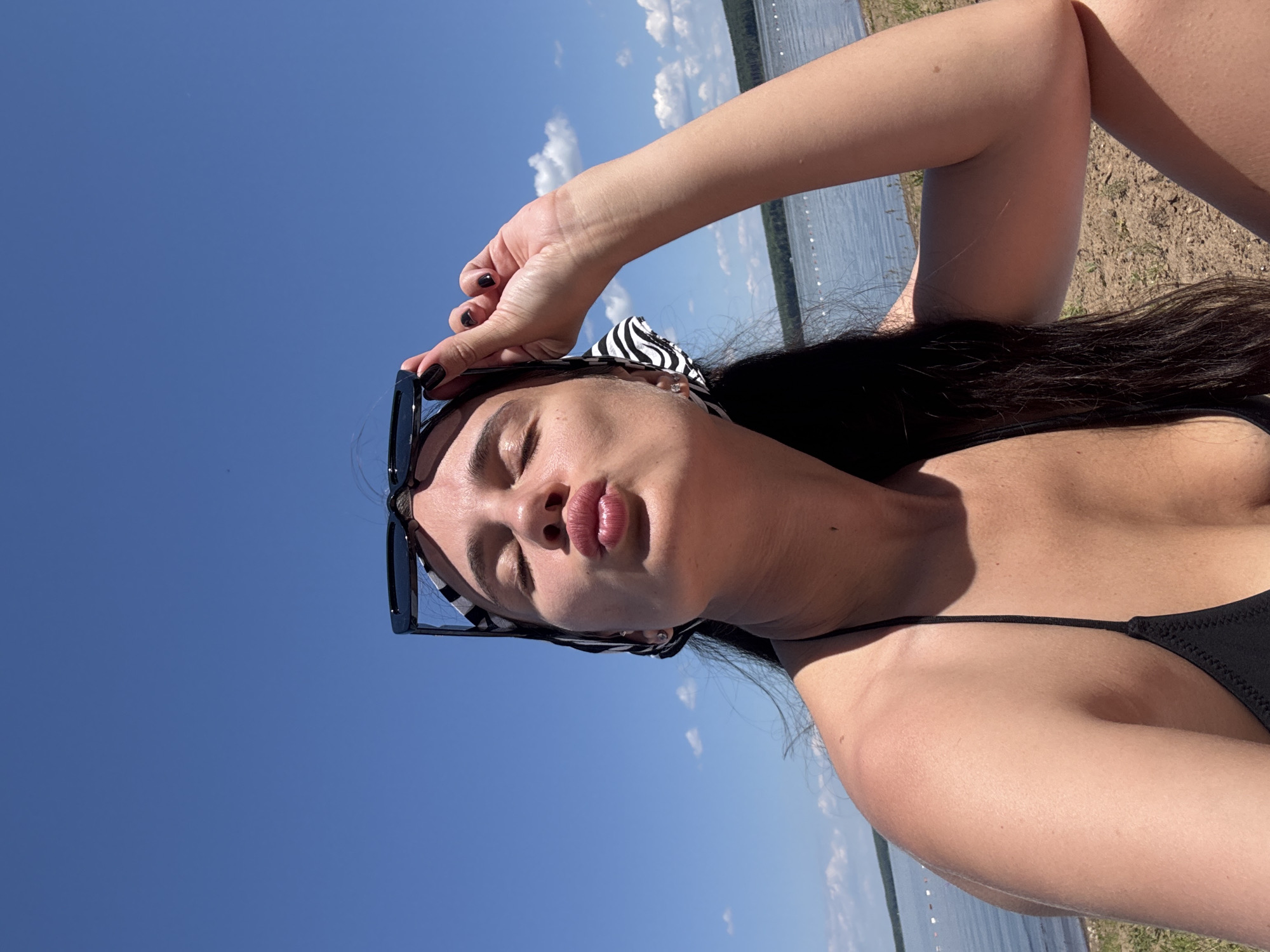 Woman takes beach selfies in Chaikovsky, Russia