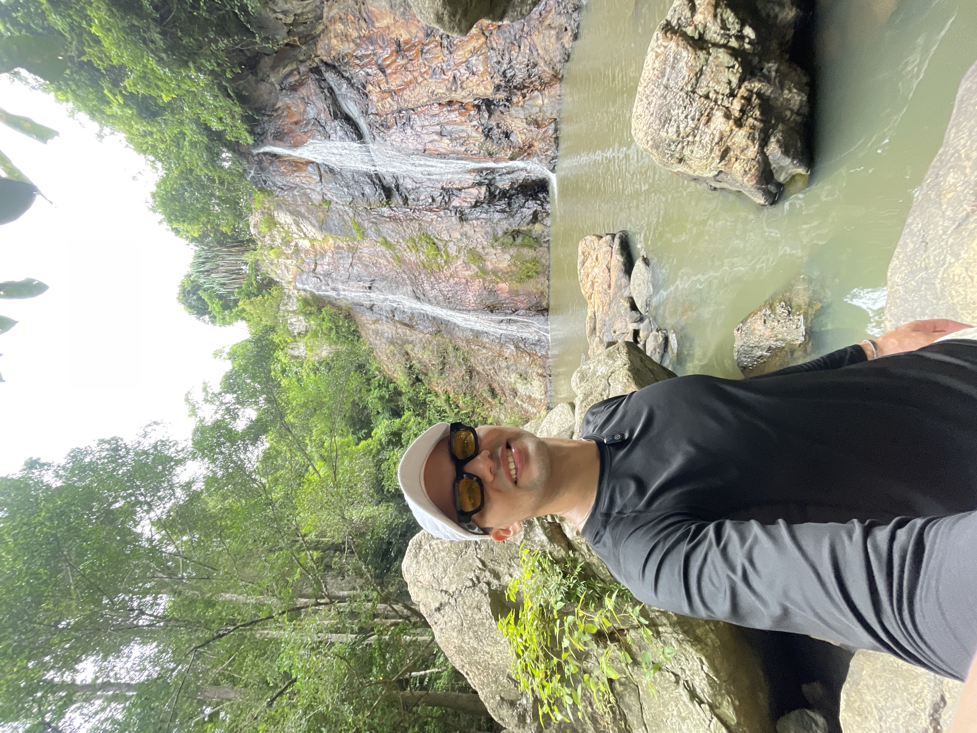 Tourist takes selfie at waterfall in Baan Thurian, Thailand