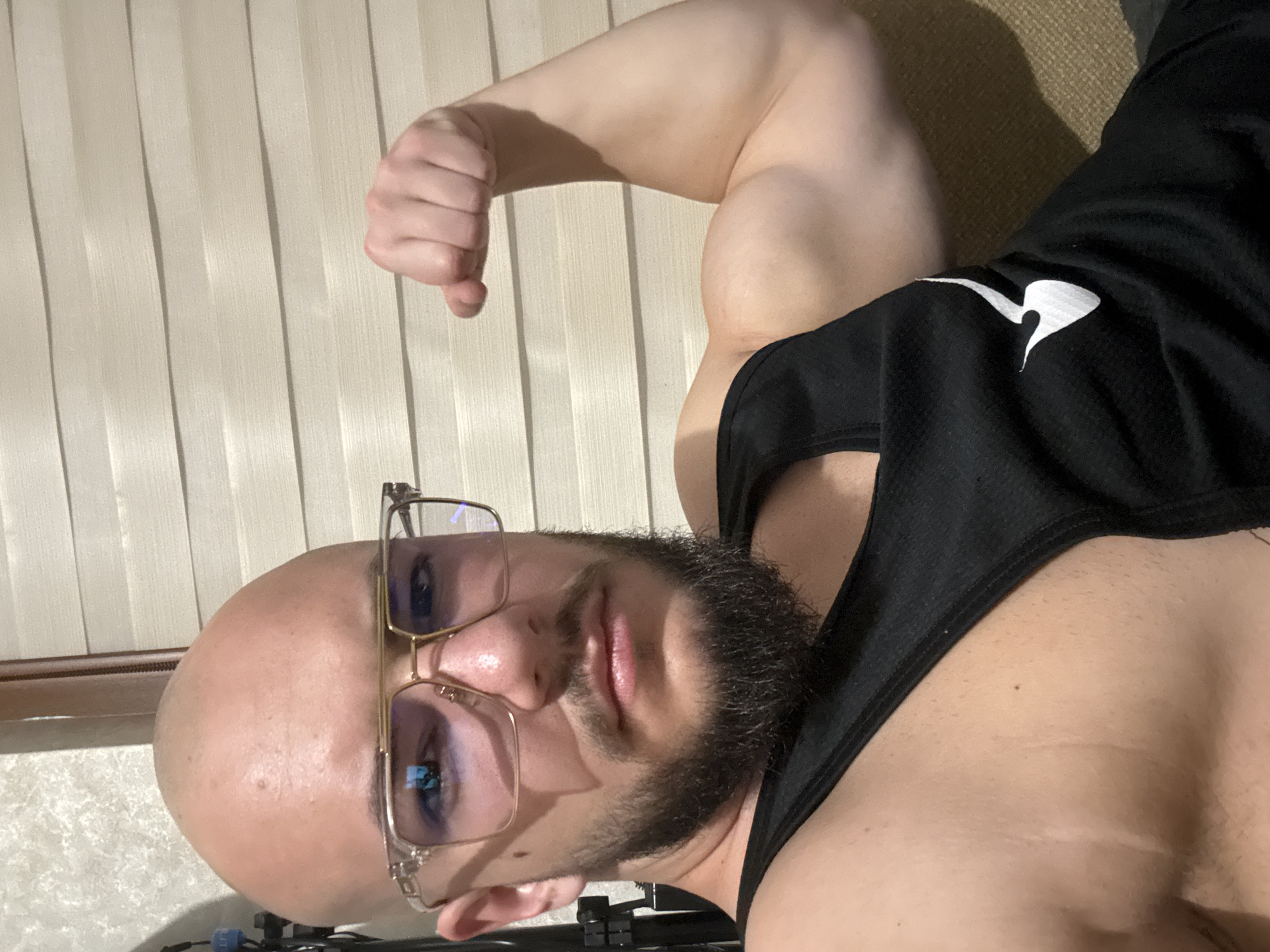Man flexes arm indoors in Sofia