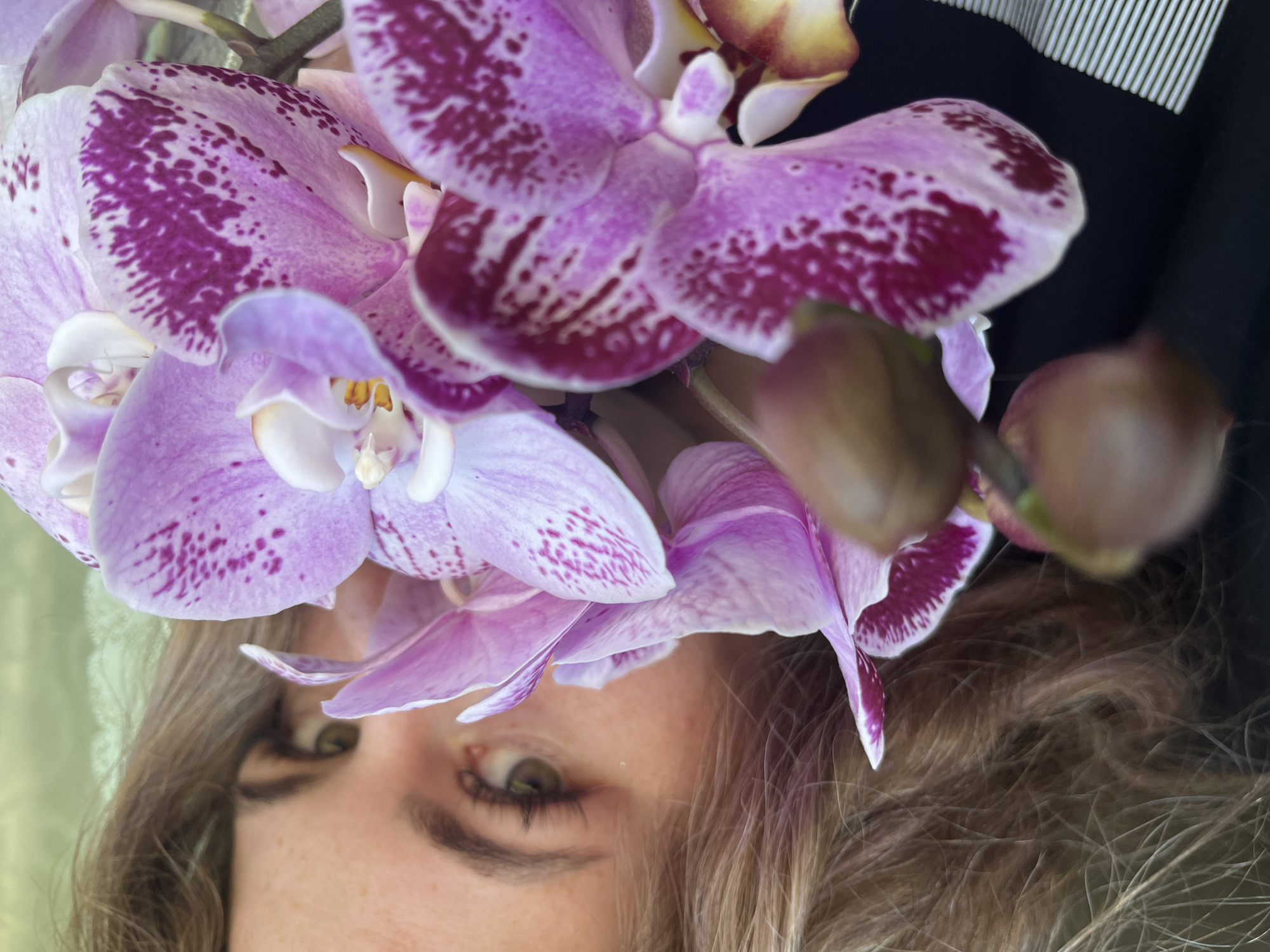 Woman photographs herself with orchids in Сосново, Russia