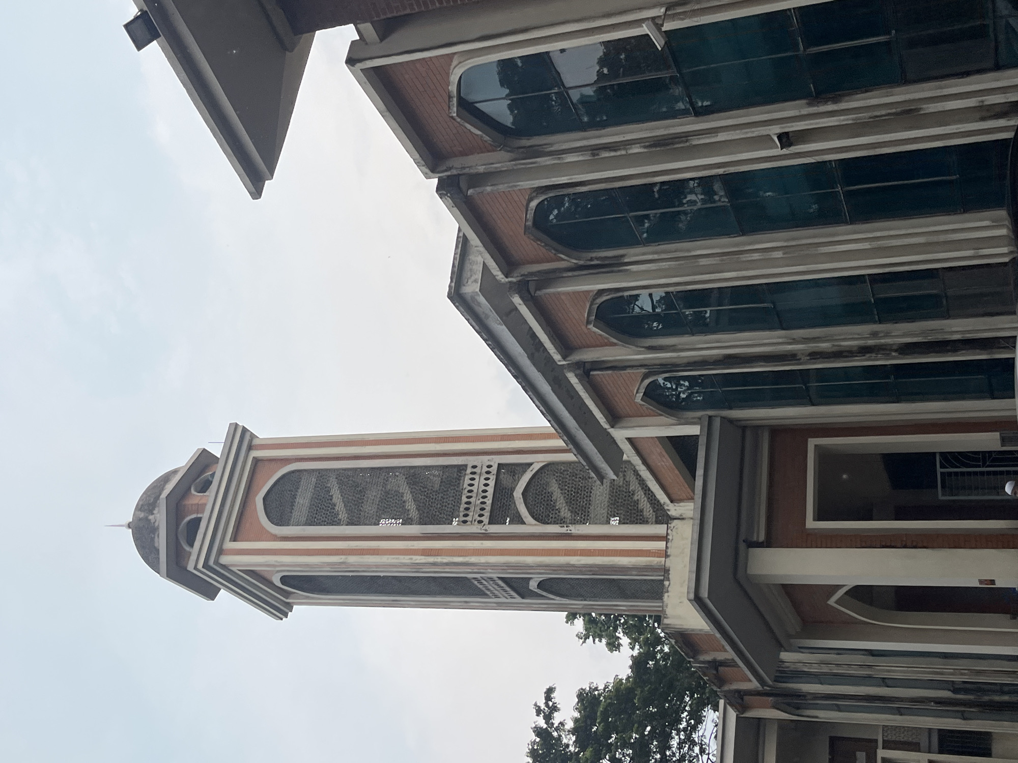 Crypto charts and a mosque minaret, Dhaka midmorning