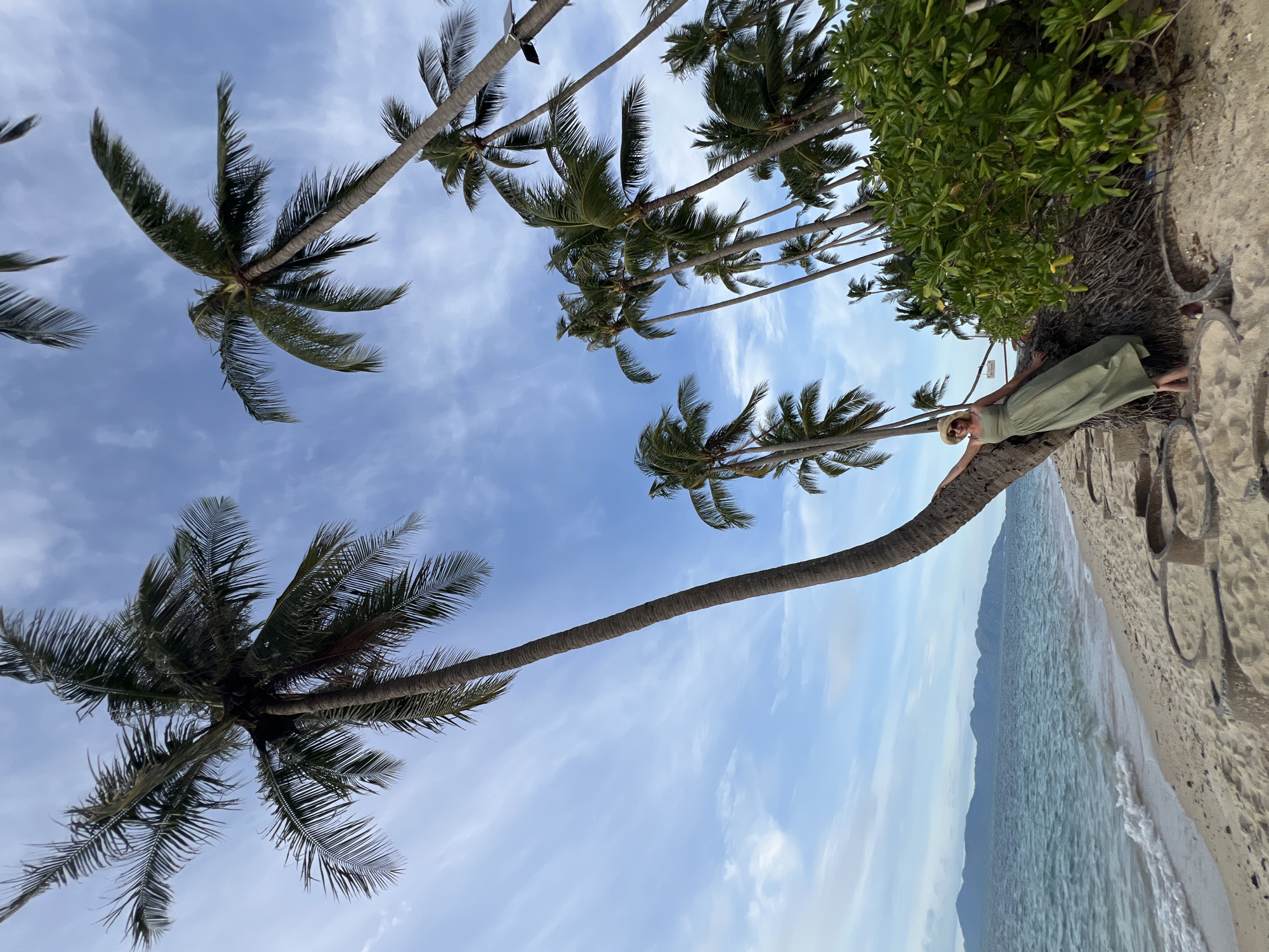 Beach day at Baan Tai: palm trees, kayaking, and shoreline activity
