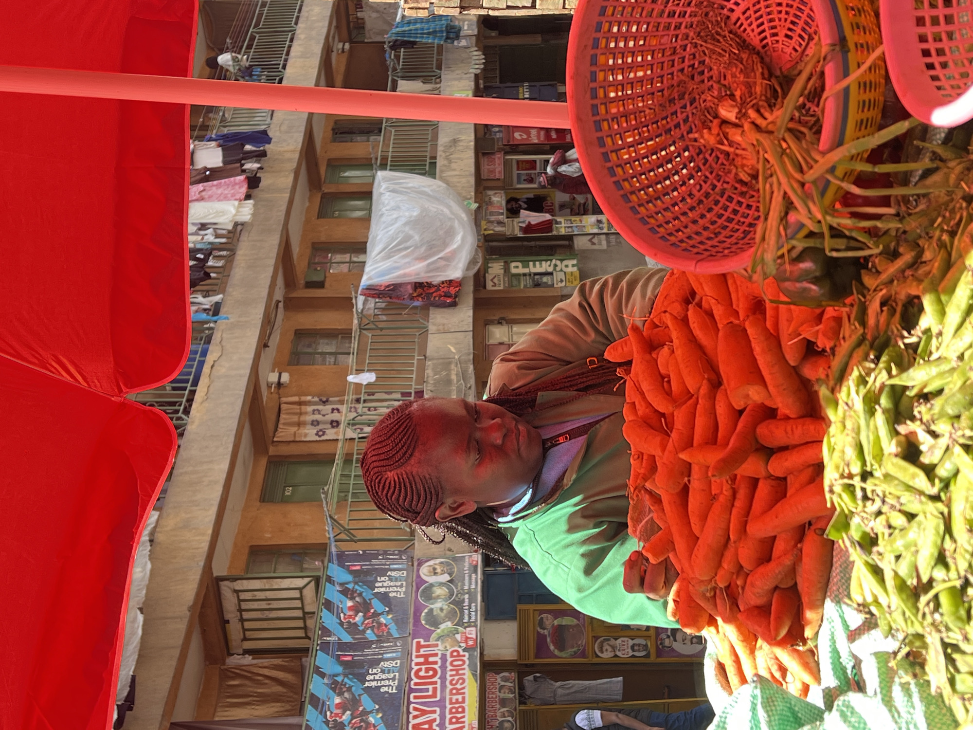 Street vendor sells fresh vegetables in Nairobi market