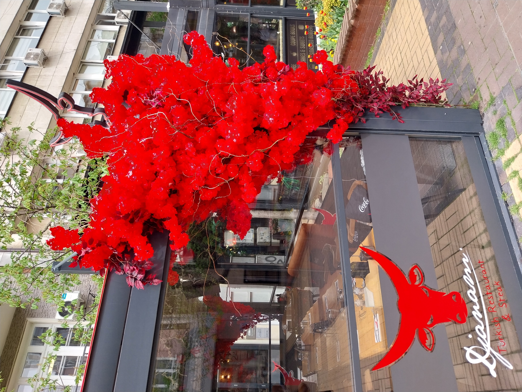 Woman walks past decorated Turkish restaurant entrance