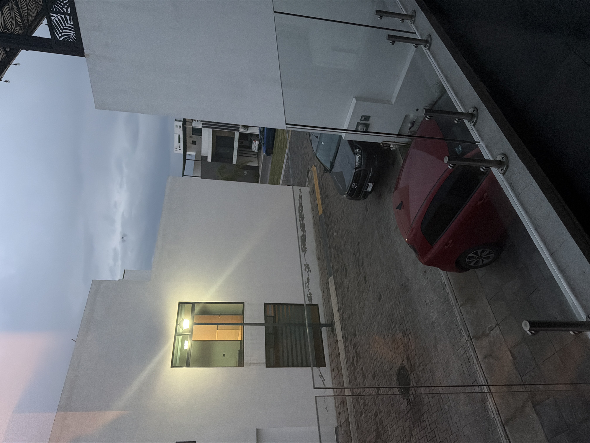 Two cars parked on brick pavement in Cholula