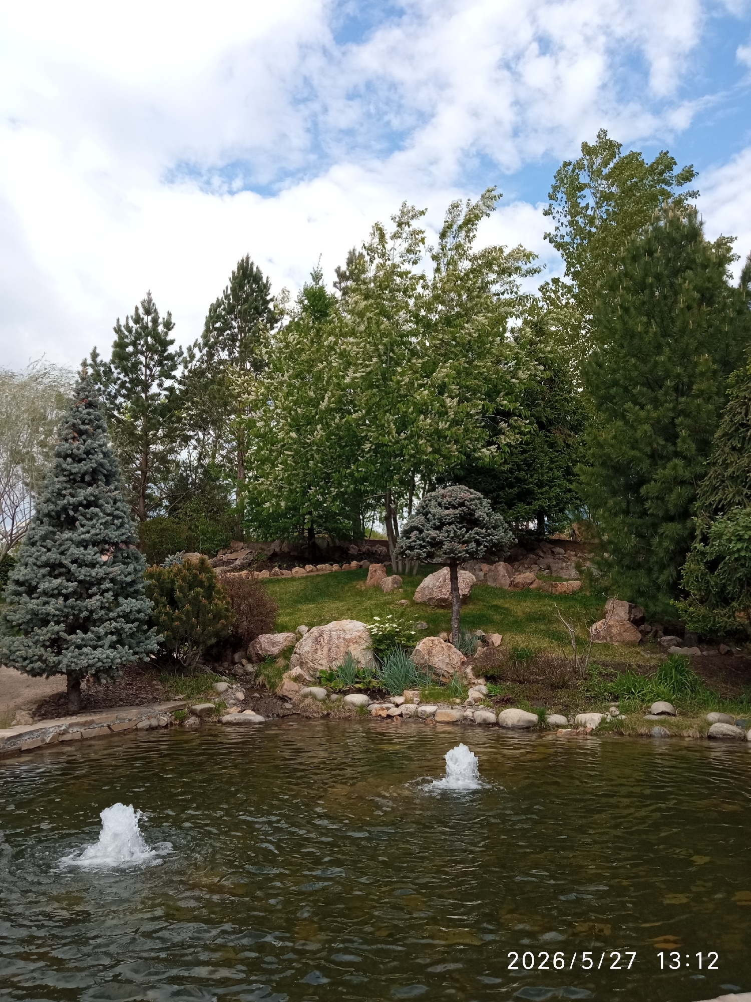 Peaceful pond with fountains observed in Krasnoyarsk park