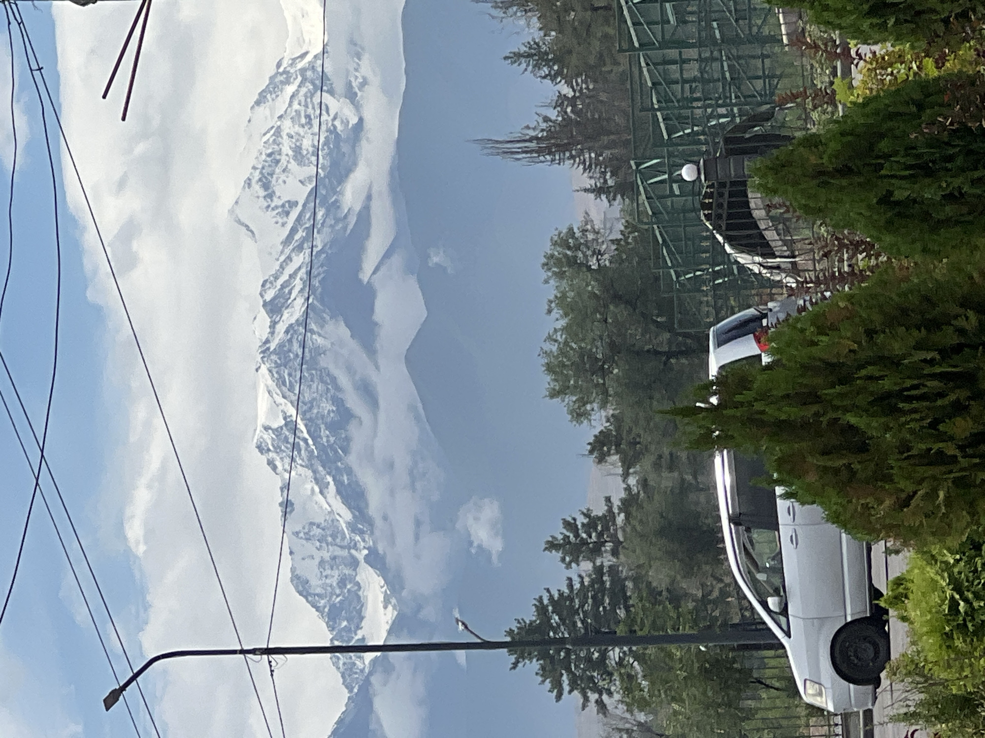 Snow-capped Tian Shan peaks loom over Bishkek on a cloudy morning