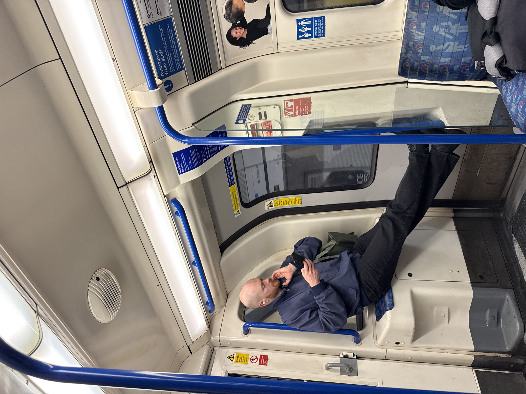 Man lies across wheelchair seats on London Underground train