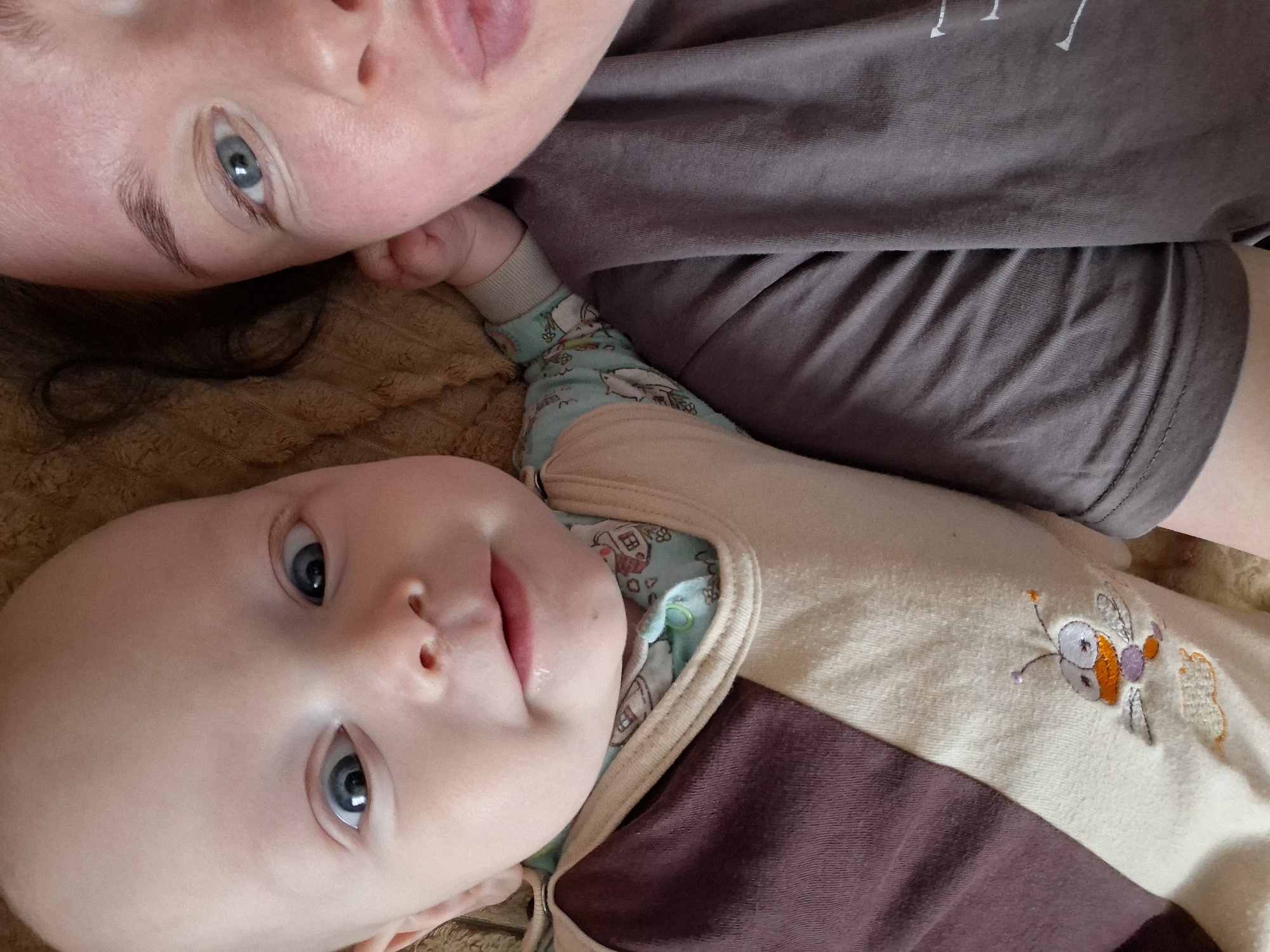 Adult and baby share quiet moment on textured surface