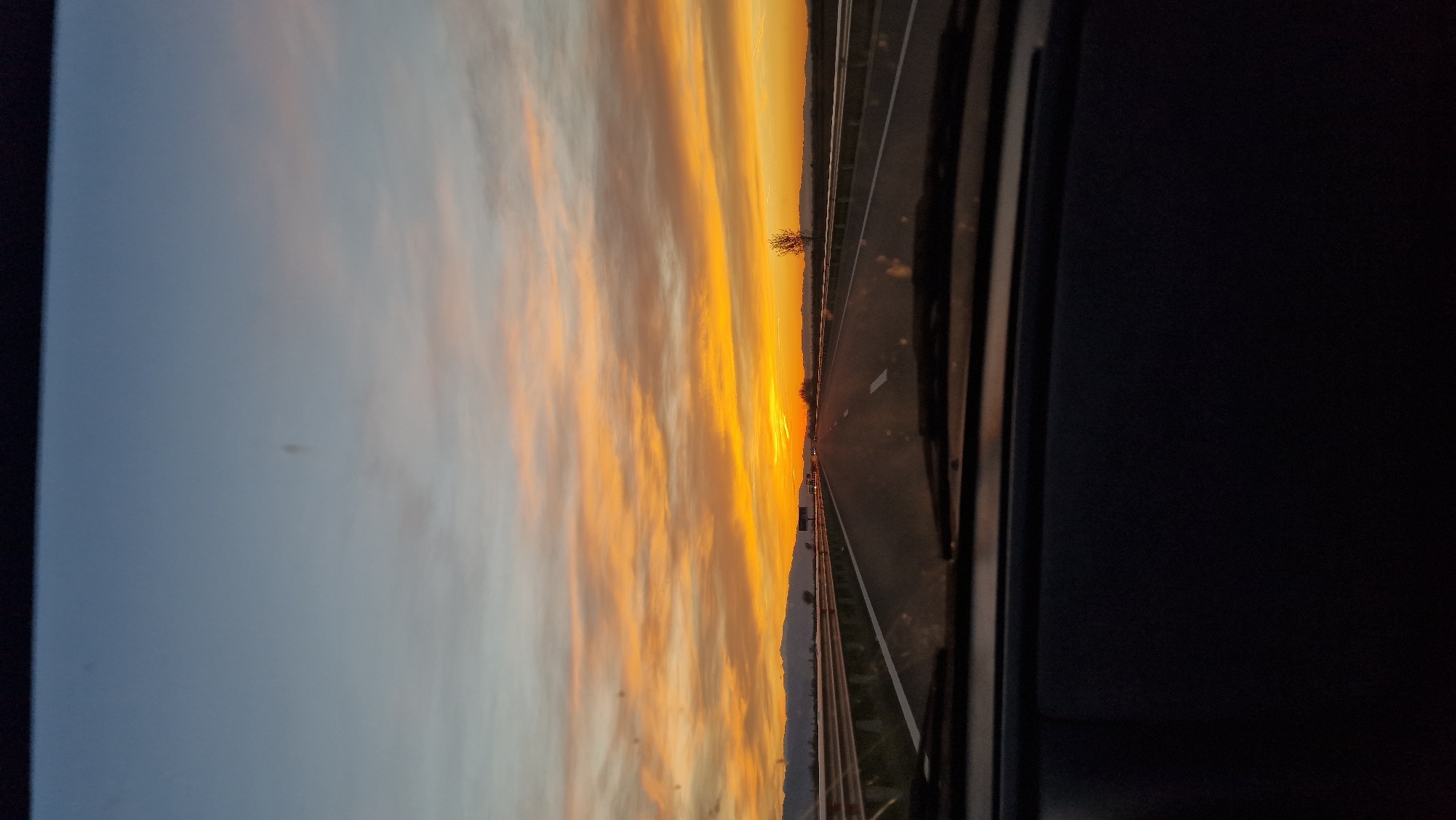 Motorist observes colorful sunset while driving near Malo Konare, Bulgaria
