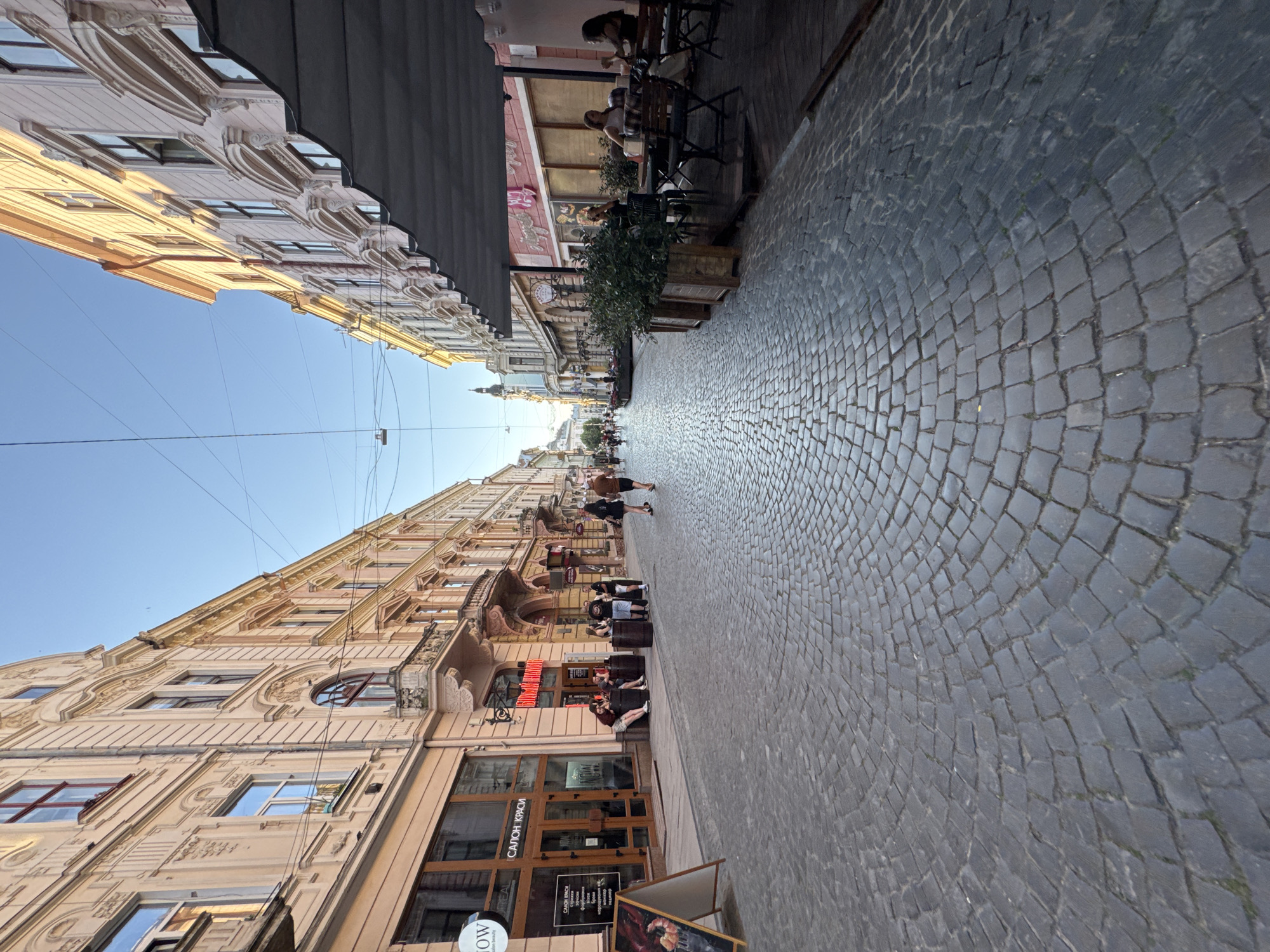 Late afternoon street life on Chernivtsi's historic cobblestone center