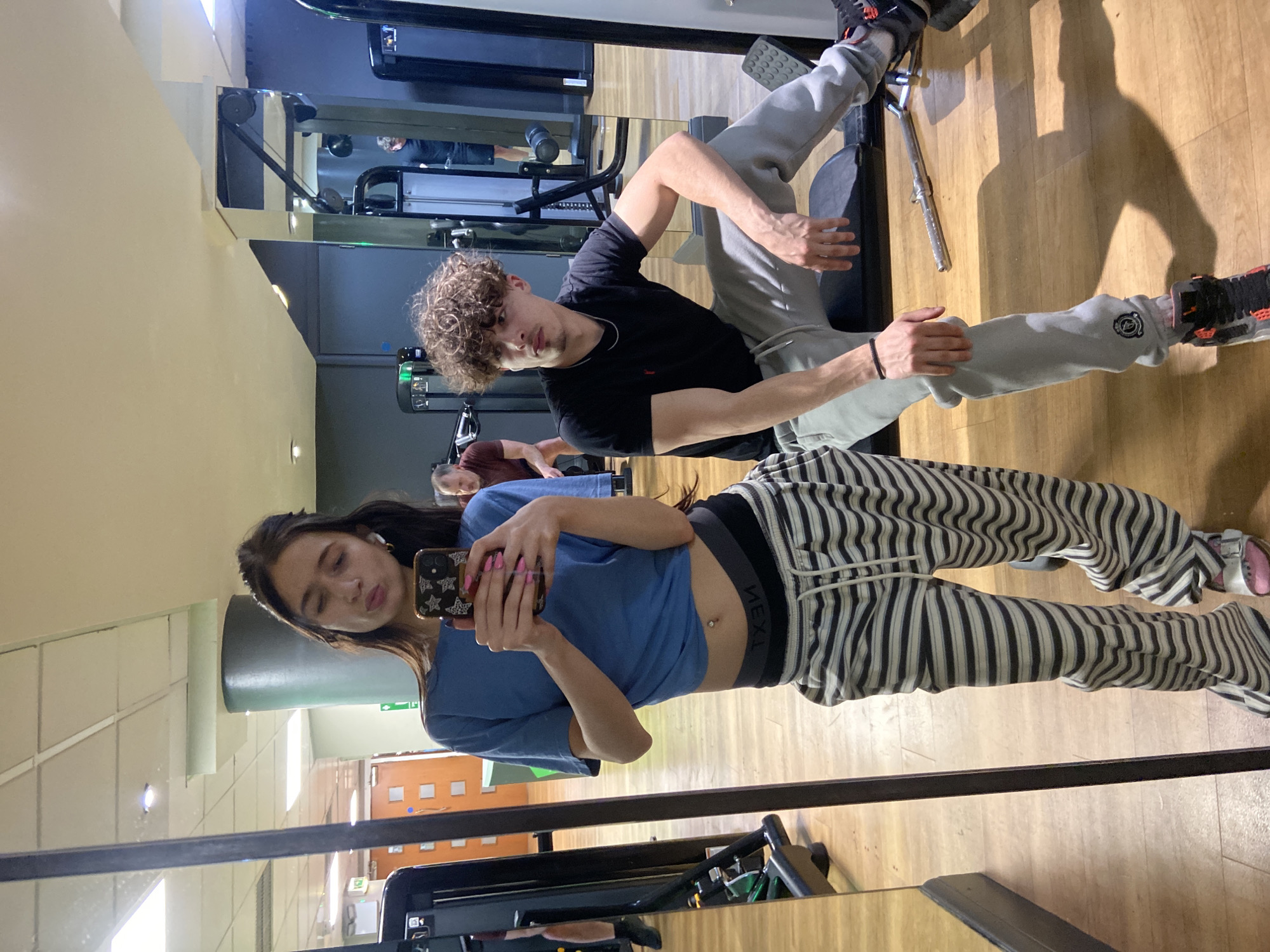 Woman takes gym selfie in London fitness center mirror