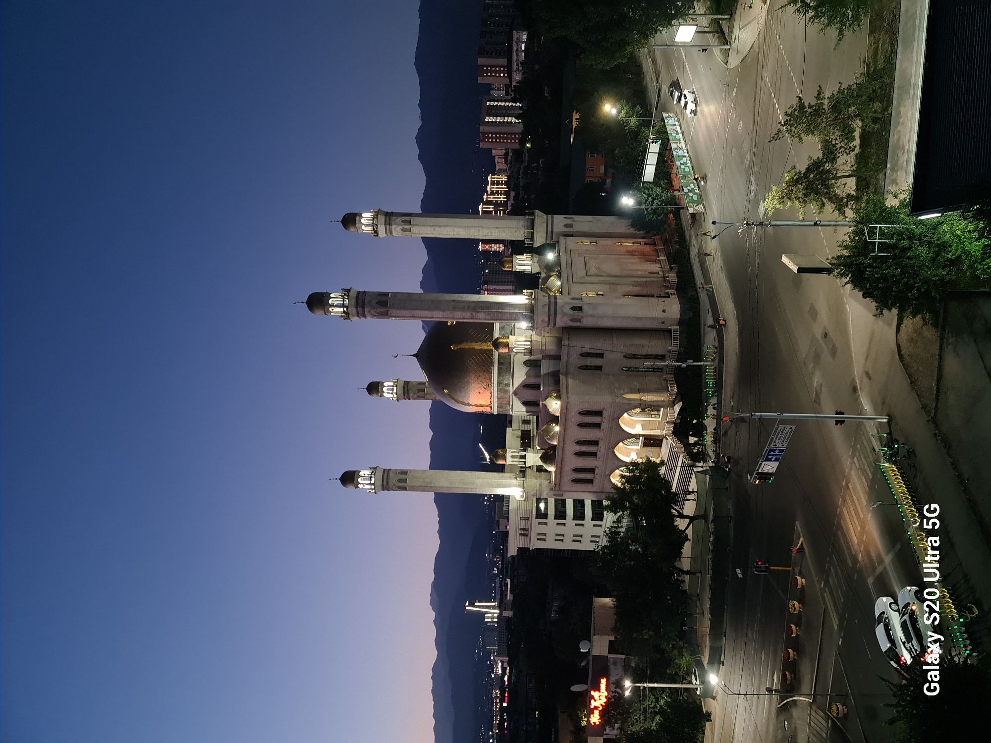 Almaty's Central Mosque glows at dusk against a colorful sky.