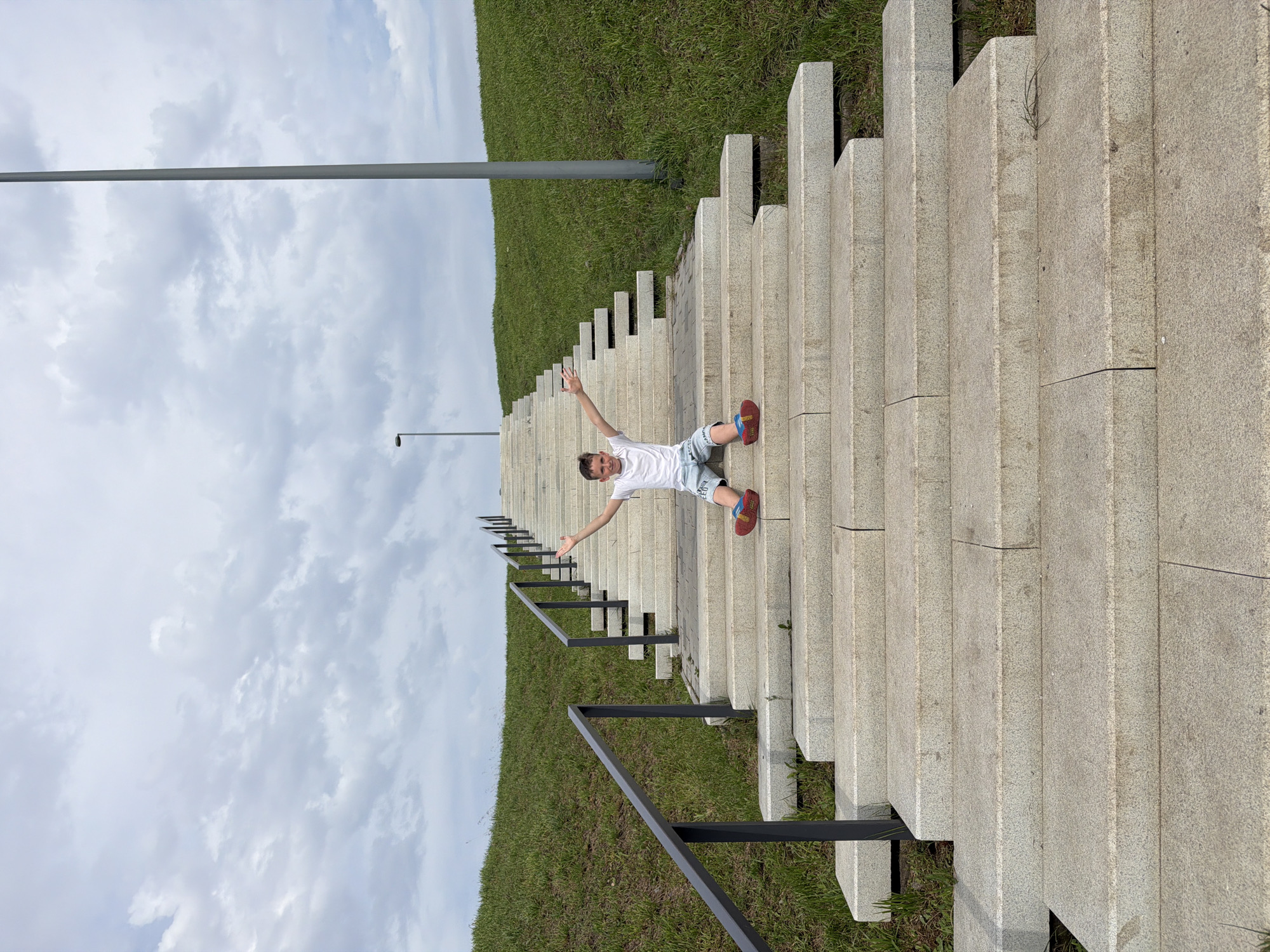 Sitting on a grand outdoor staircase in Yekaterinburg