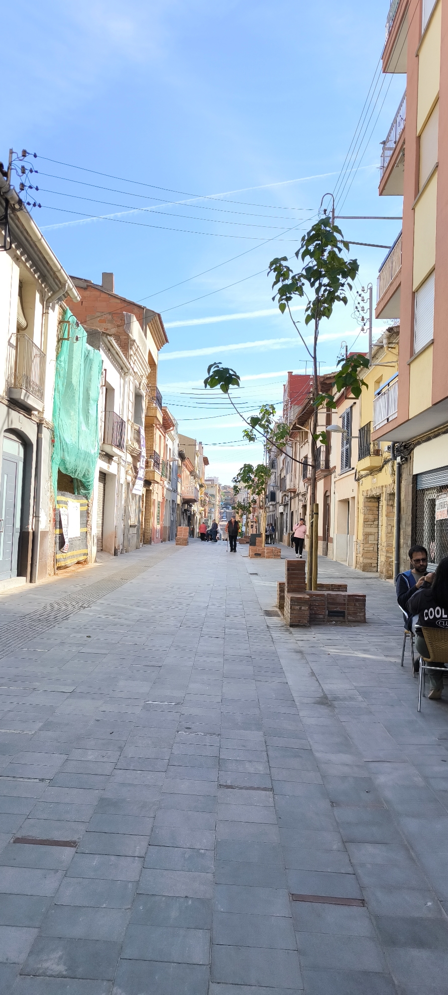 Morning street life and community gathering documented in Ripollet