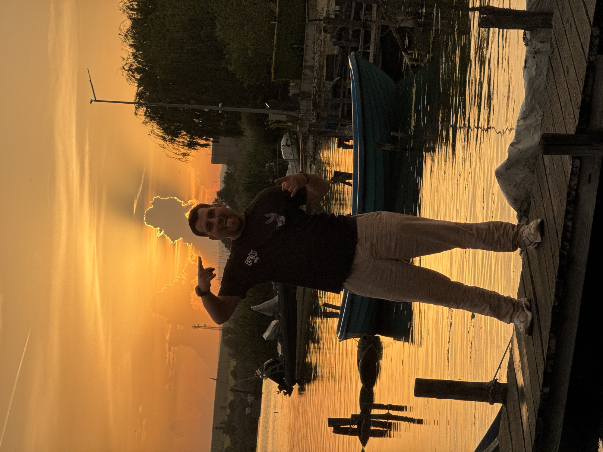 Sunset gathering at Bulgarian lakeside dock draws peaceful observers