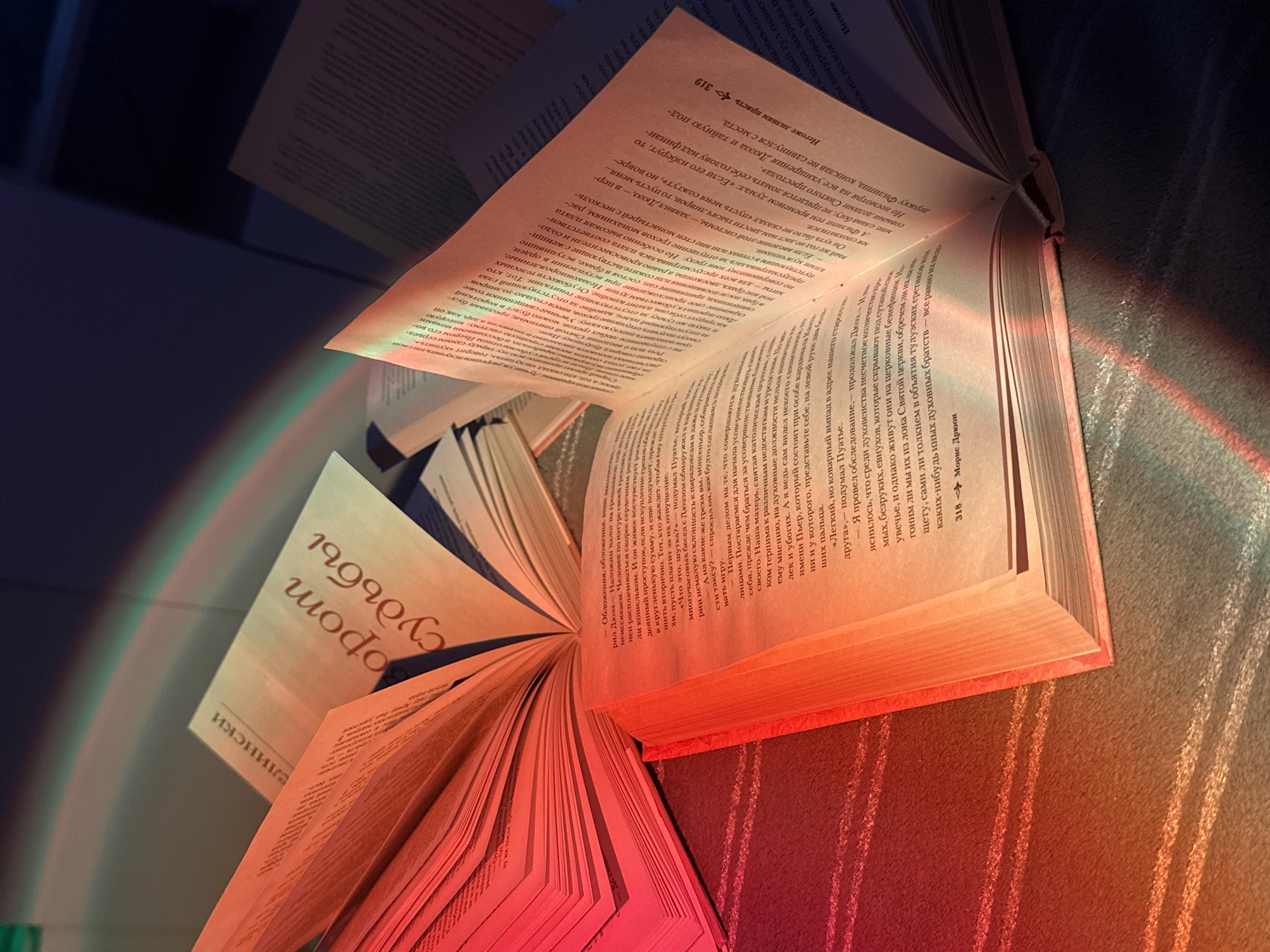 Person reads Russian books under rainbow lighting effects