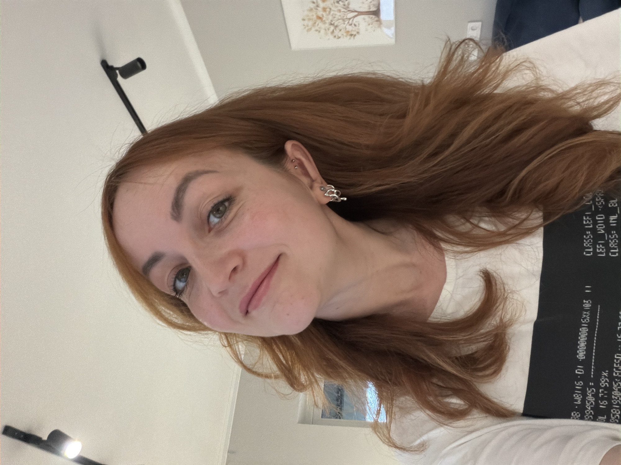 Woman photographed in mirror selfie, upward pose in Chaikovsky