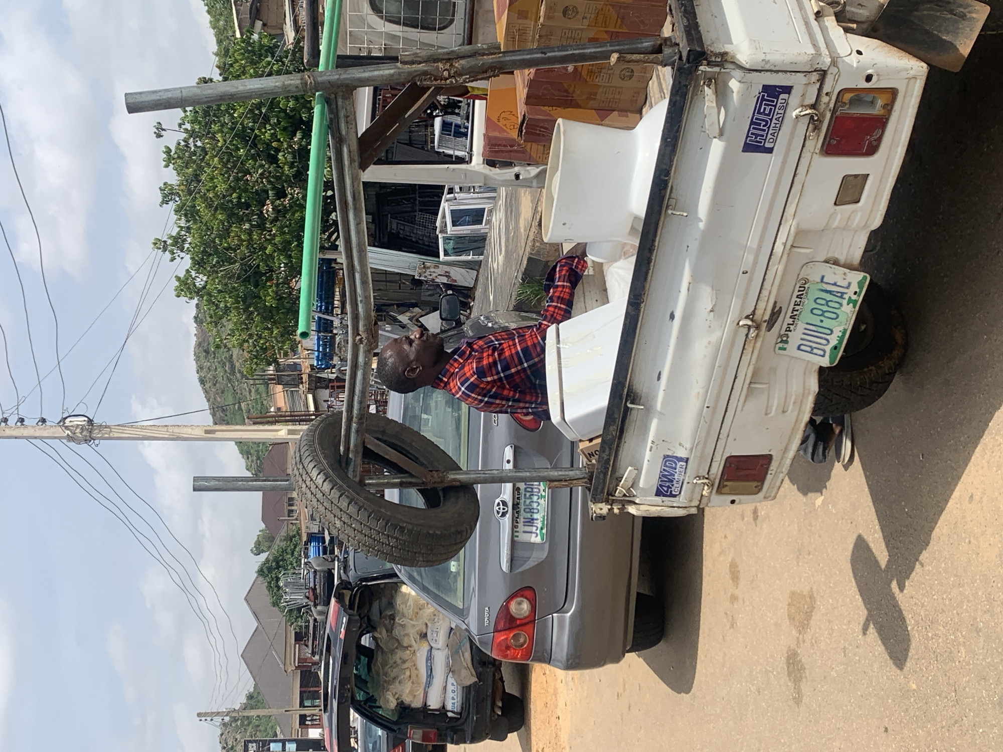 Midday street life and commerce in Gura Top, Nigeria