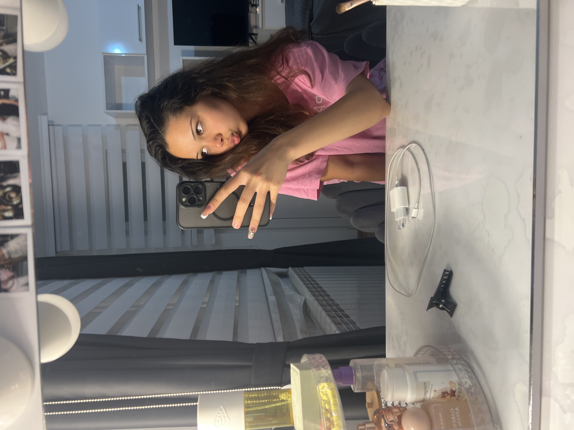 Woman takes multiple mirror selfies, Audi logo projection captured