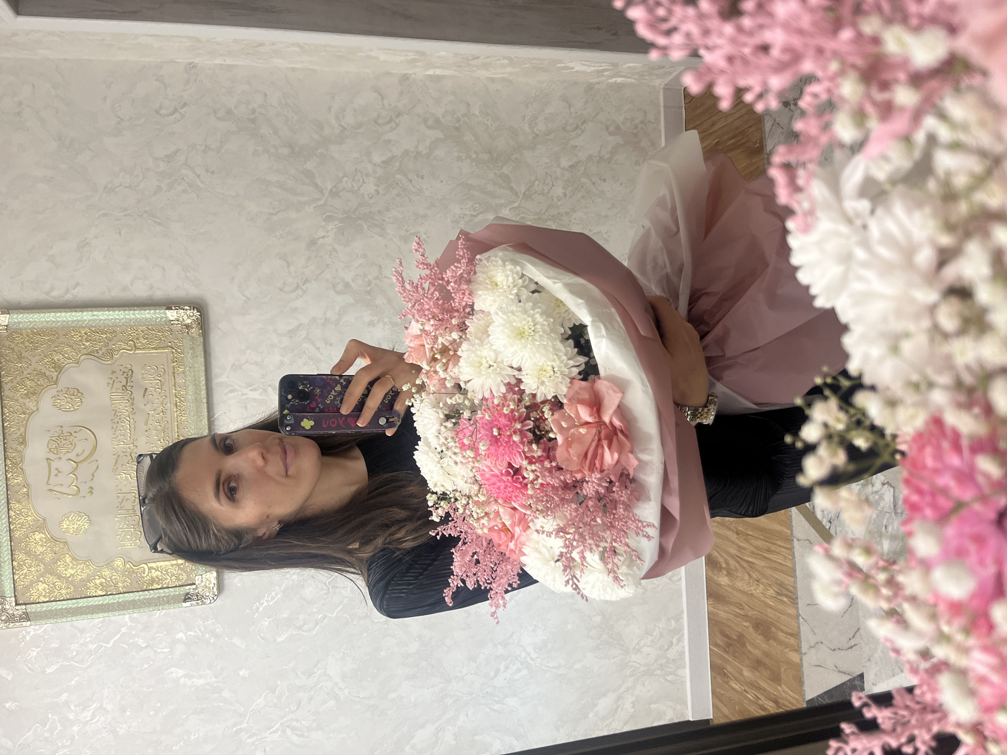 Woman captures flower bouquet selfies, quiet moments with child