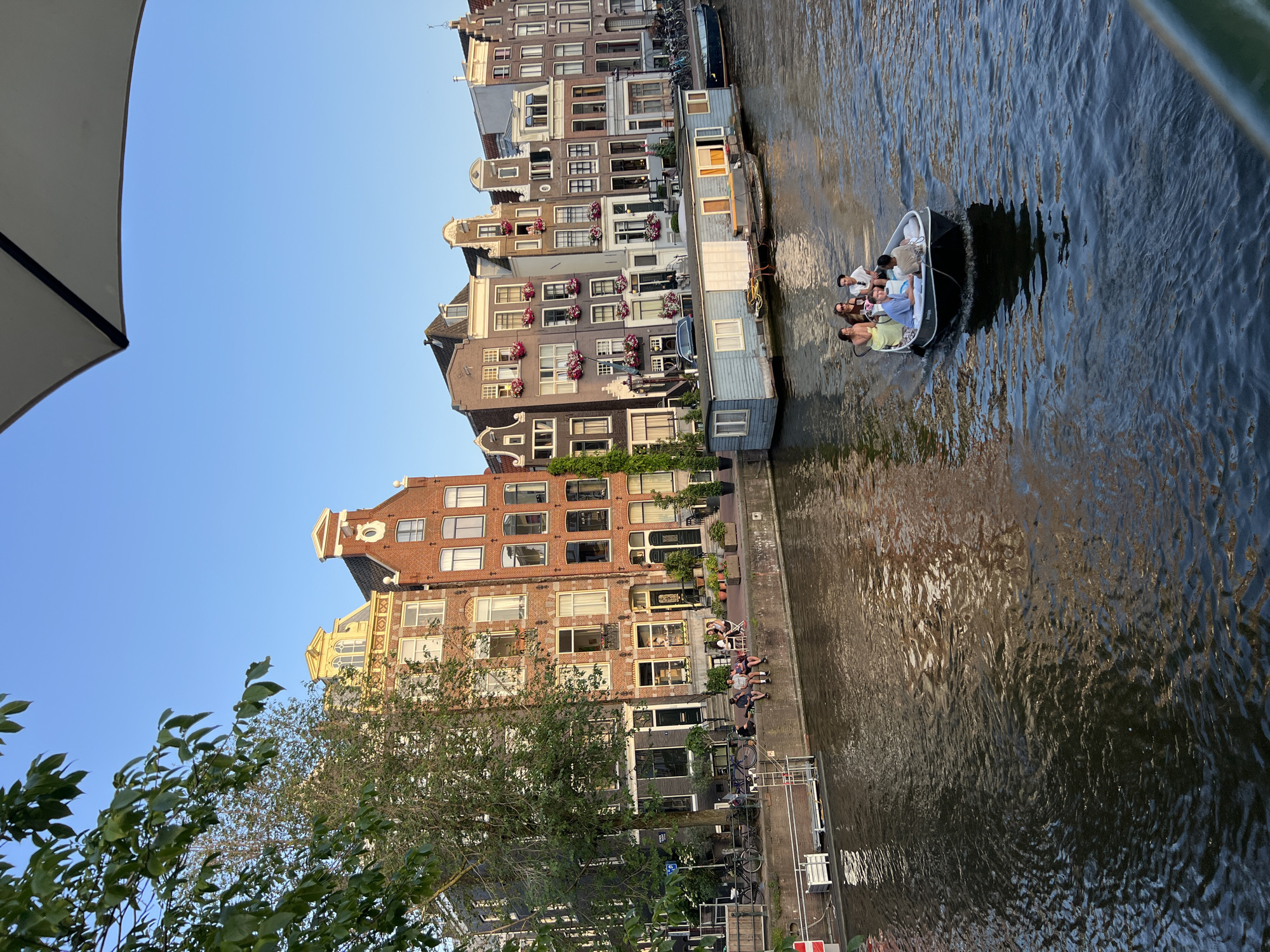 Everyday Amsterdam street life on a clear summer evening