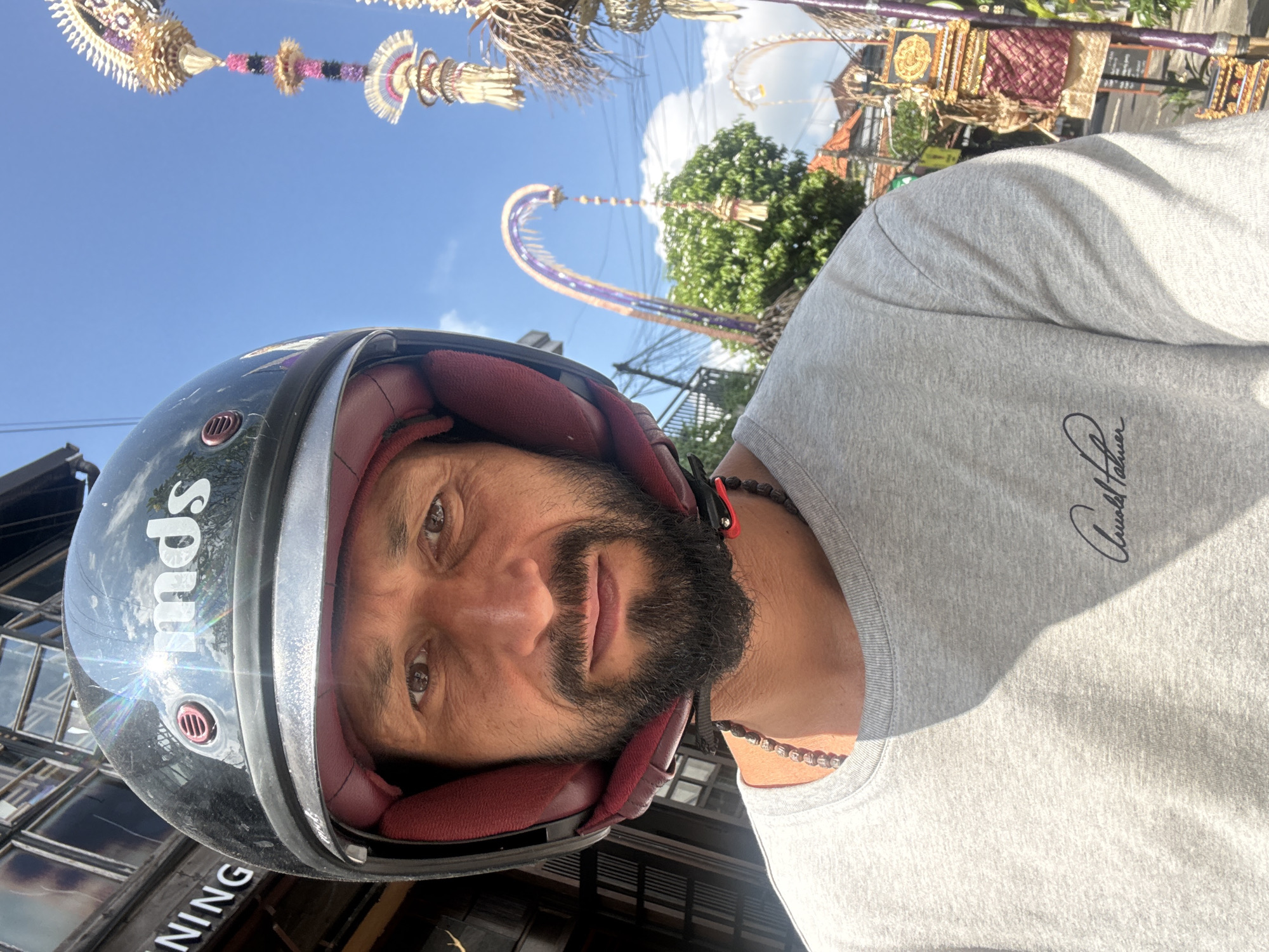 Helmeted rider and SUV on an Ubud road