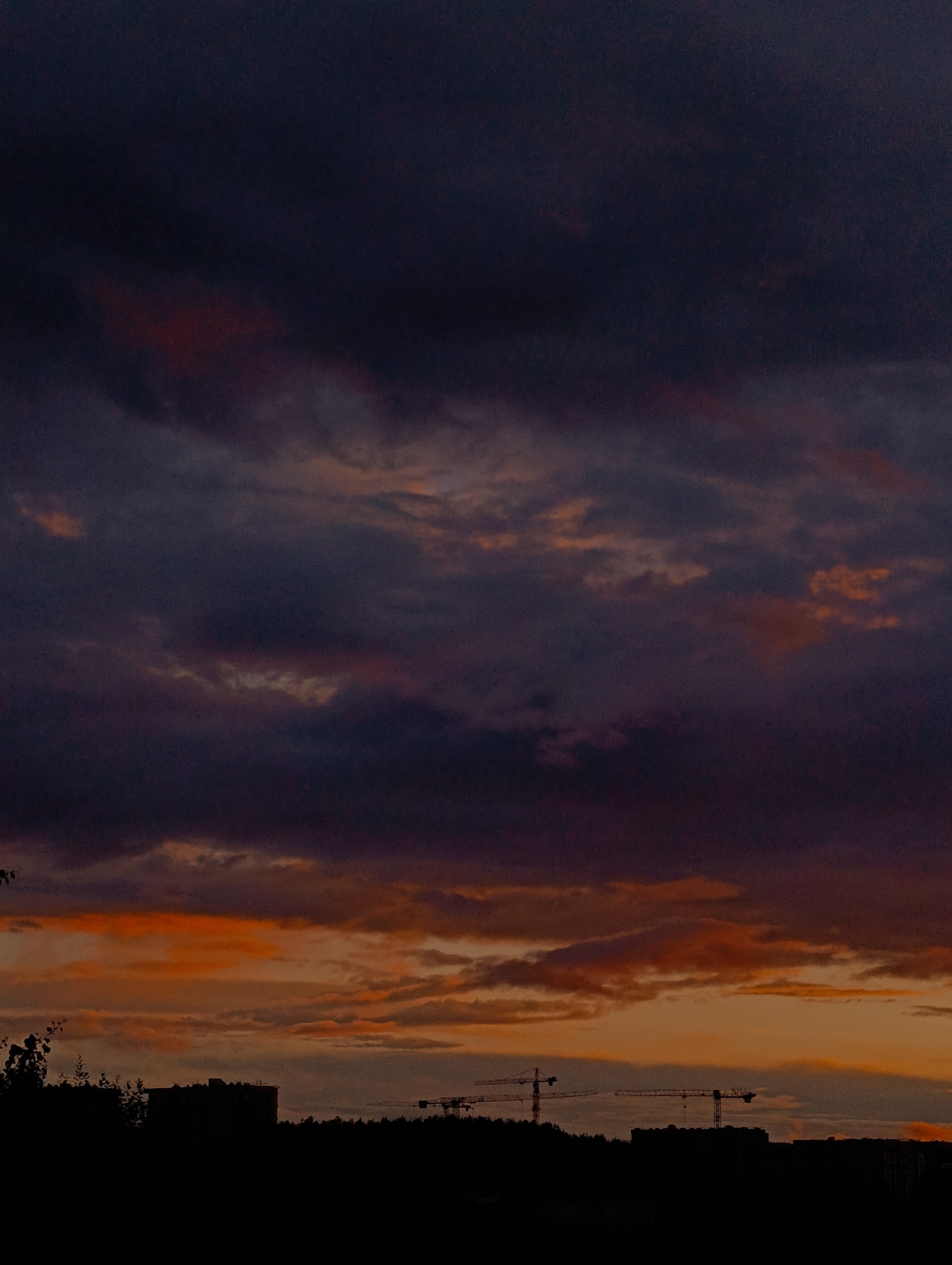 Stormy sunset sky over Minsk, clouds lit orange and purple