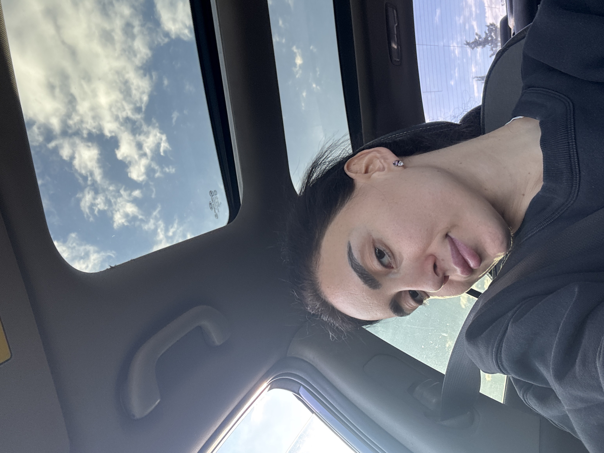 Woman photographed in car during early morning drive in Tbilisi