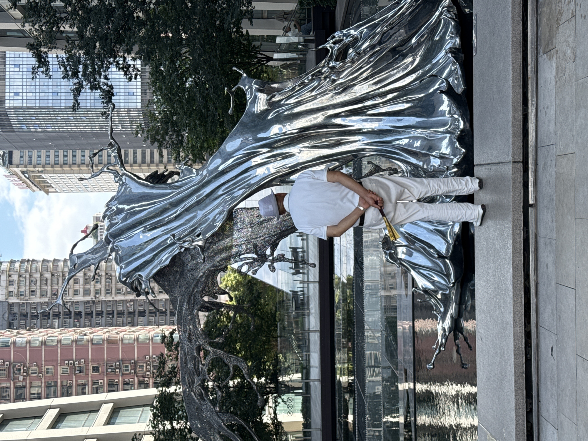 Around a striking metallic sculpture in Chongqing's Yuzhong District