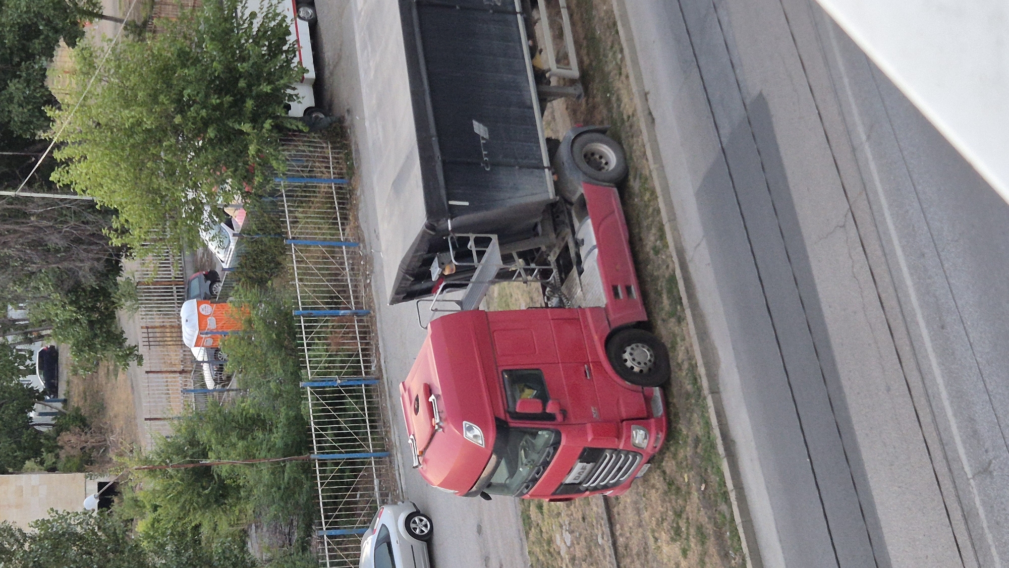 Lovech at dusk: stadium, market stalls, and a parked truck