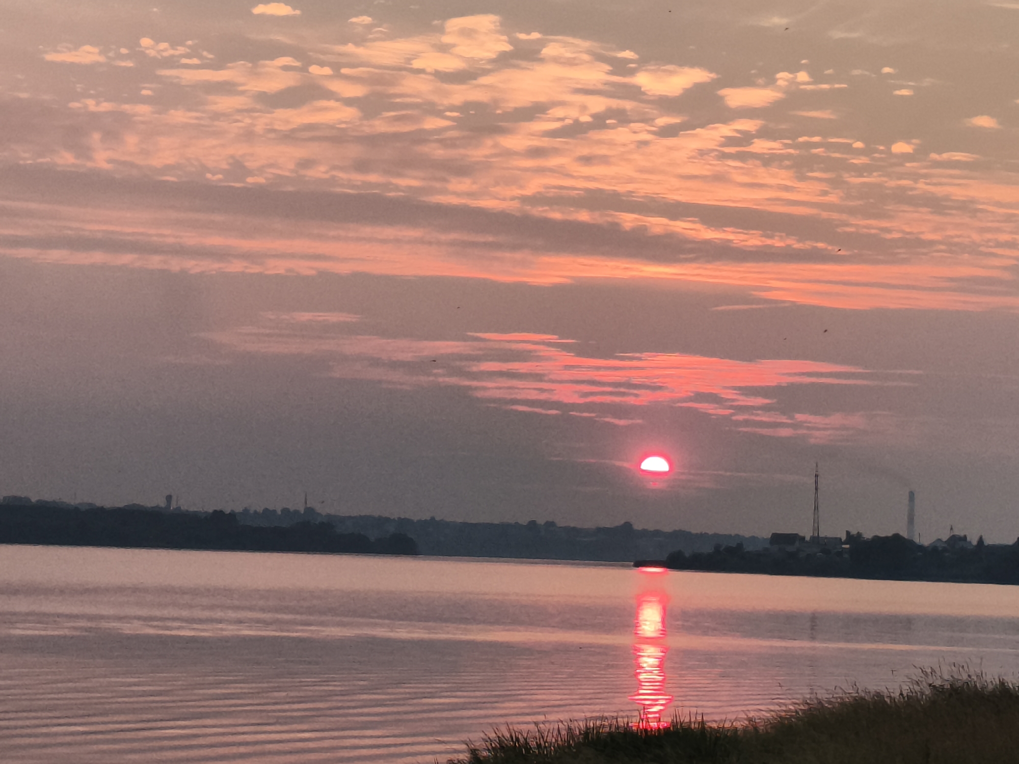 Quiet sunset over still water near Mencherep, Russia